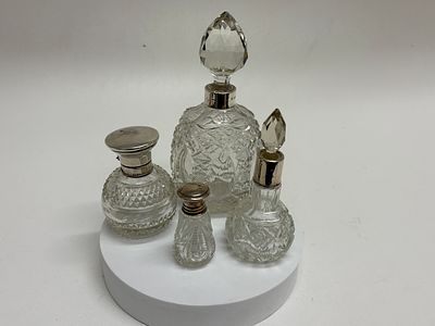 A Collection of Four Late Victorian and Edwardian Sterling Silver-Mounted Cut Glass Perfume and 