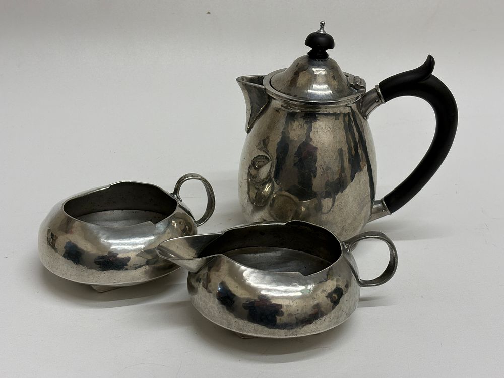 Lot 65: Liberty & Co. Three-Piece Arts and Crafts 'Tudric' Pewter Partial Tea Service