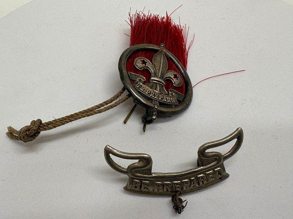 Lot 70: A Pair of Vintage Assistant Scoutmaster Hat Plume and Motto Badges