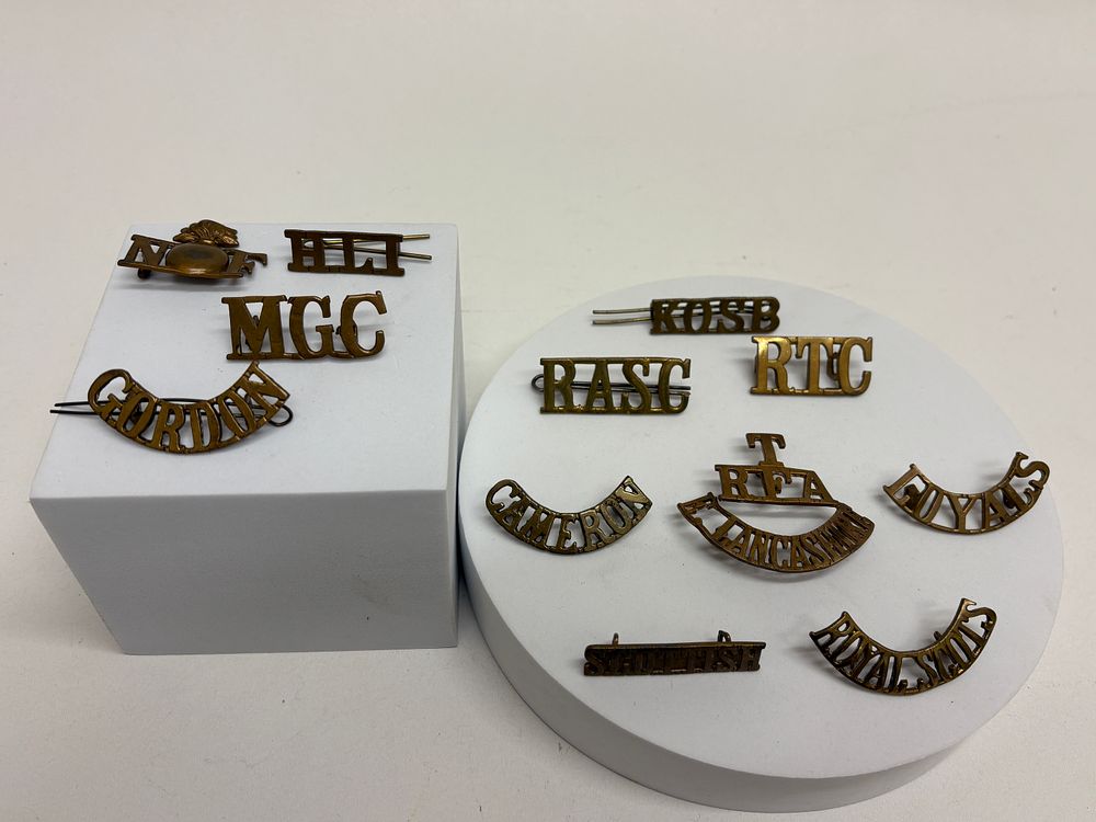 Lot 73: A Collection of British Military Brass Shoulder Titles and Insignia