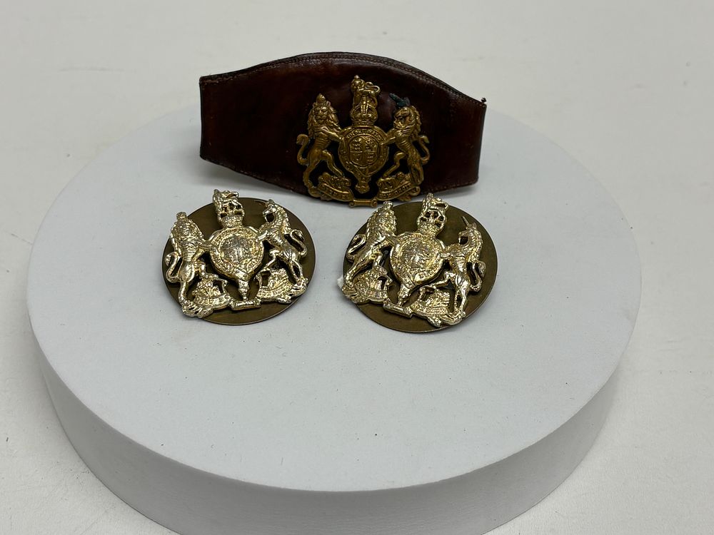 Lot 76: A Trio of British Army Warrant Officer Class 1 (WO1) Royal Arms Insignia and Leather Wrist Strap