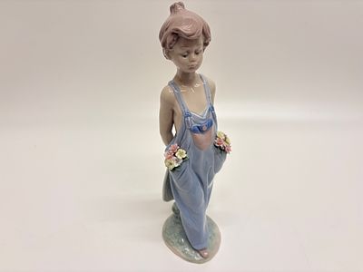 Lladro, Pocket Full of Wishes (7650). This Lladro glazed porcelain figurine, titled Pocket Full 