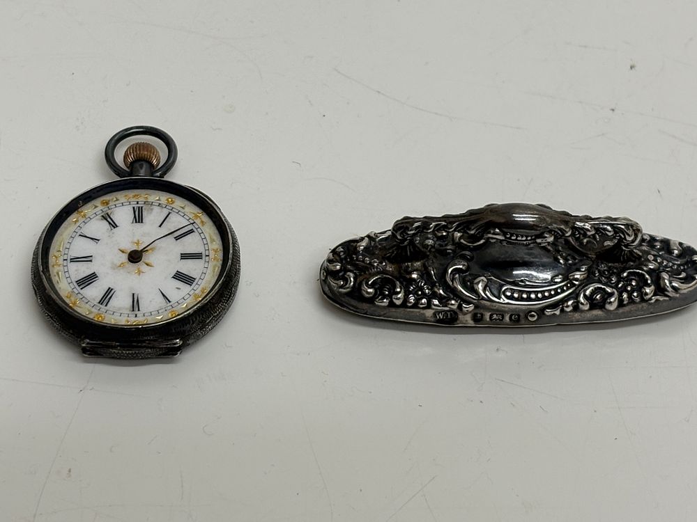 Lot 218: A .935 silver open face pocket watch and an Edwardian sterling silver repousse handle 40g Gross