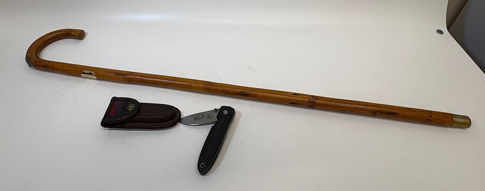 Lot 672: Two equestrian-related items comprising a wooden horse measuring walking stick and a Buck folding knife