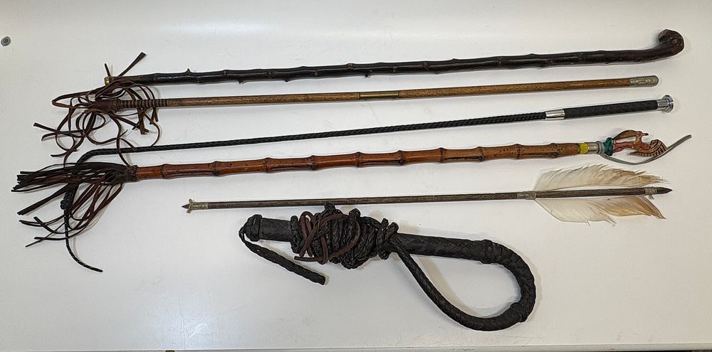 Lot 673: An Assortment of Walking Sticks, Riding Whips, and a Primitive-Style Arrow