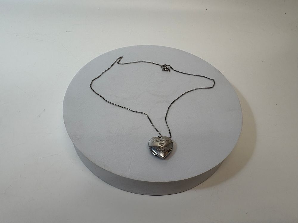 Lot 1A: A sterling silver and 9-carat gold heart-shaped locket necklace with Pct Gold internal Heart with Diamond