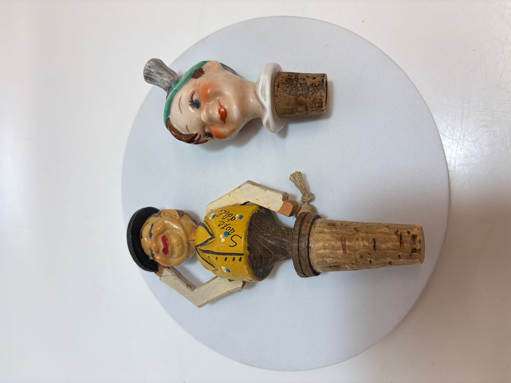 Lot 485: A Pair of Vintage Novelty Bottle Stoppers Including an Articulated Wooden Alpine Souvenir