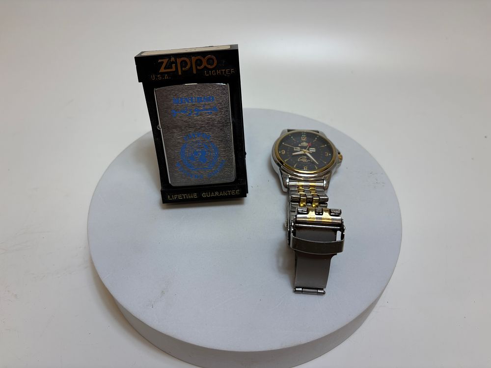 Lot 491: Two Items: A UN MINURSO Zippo Lighter and an Astro Calendar Wristwatch
