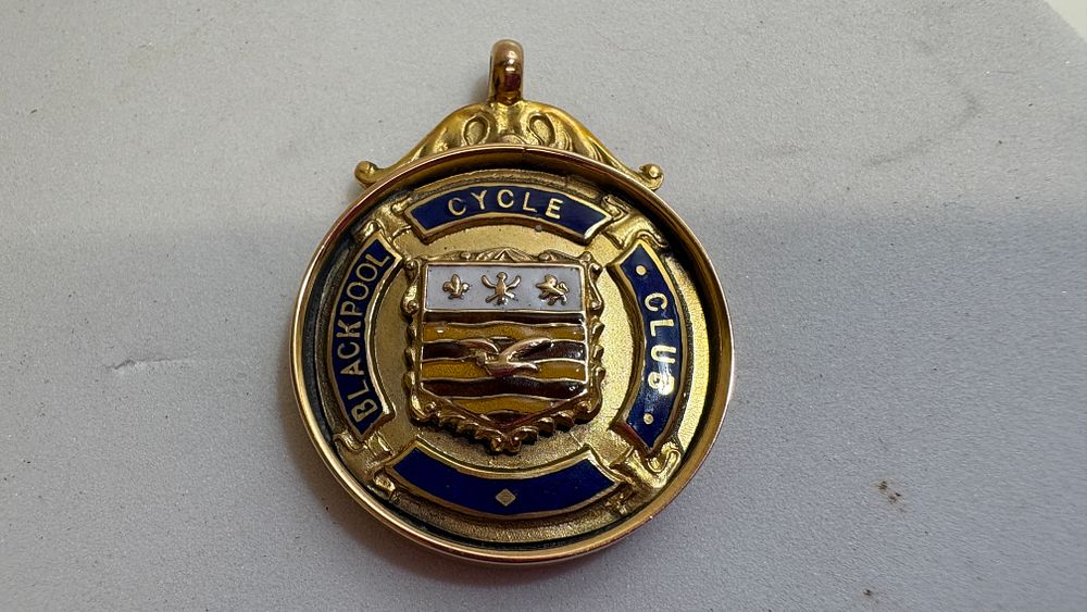 Lot 3B: A 9 Carat Gold and Enamel Blackpool Cycle Club Prize Medal by William Hair Haseler, 1926 circa 9.9g