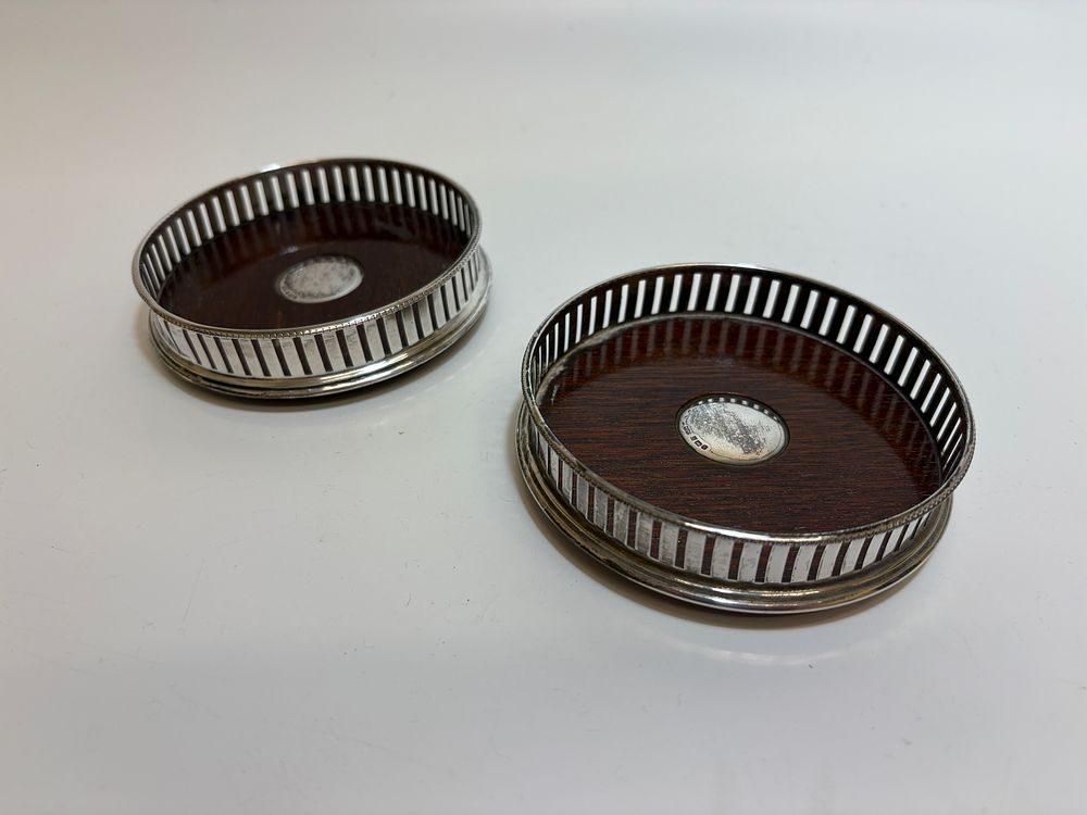 Lot 4G: A Pair of George V Sterling Silver-Mounted Mahogany Wine Coasters, Mappin & Webb Ltd, Birmingham 1918 circa 112g gross
