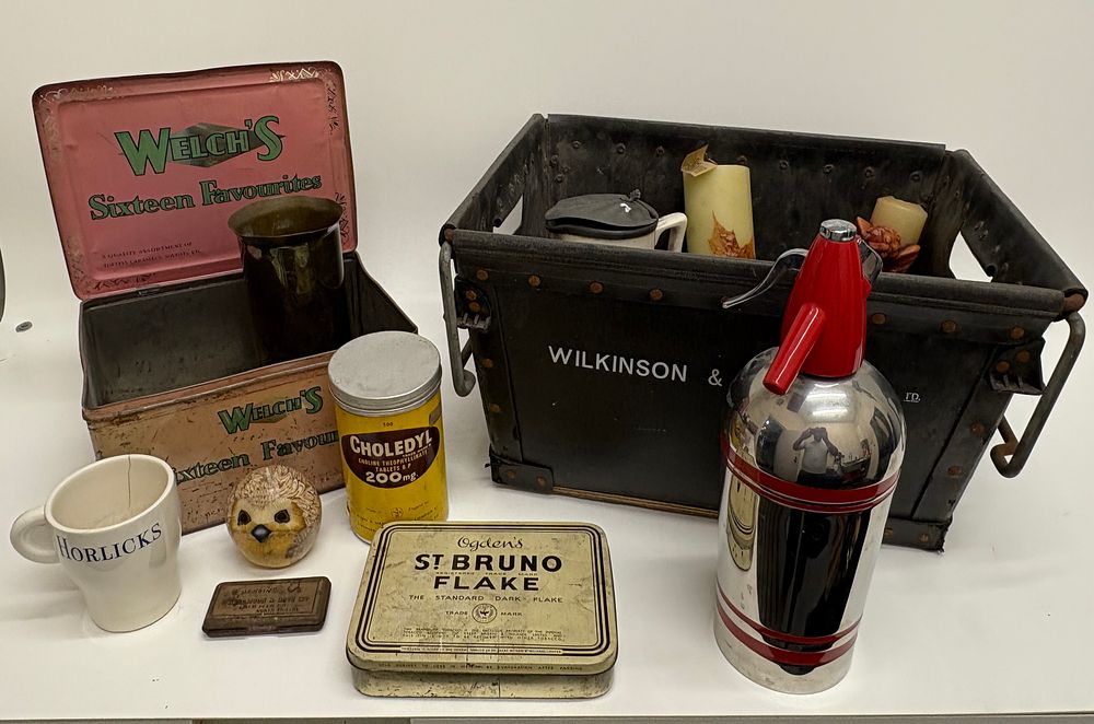 Lot 559: An Assortment of Vintage Advertising Tins, Industrial Storage Crate, and Household Collectables
