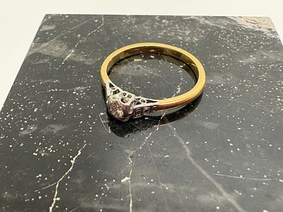 An Art Deco Yellow Metal and White Metal diamond solitaire ring. An Art Deco style diamond 