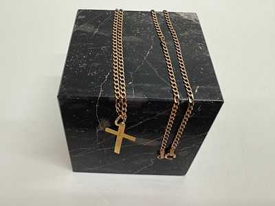 A 9ct yellow gold cross pendant and curb link chain Circa 3g. A 9ct yellow gold necklace 