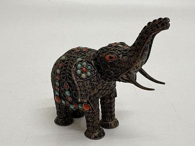 A Tibetan Silver Filigree and Inlaid Elephant Figurine circa 49.5g gross. A silver figurine of 