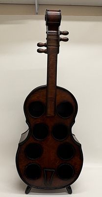 A large freestanding wooden cello shaped eight bottle wine rack 102x35cm. A freestanding wooden 