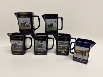 A Collection of Six Seton Pottery Martell Cognac Grand National Commemorative Water Jugs. A 
