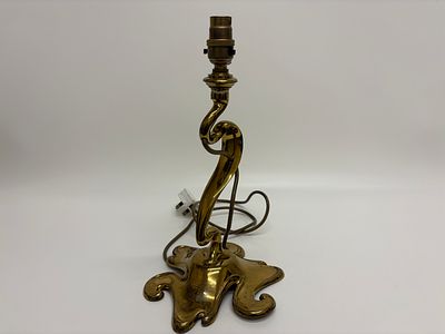 An Art Nouveau Hinks cast brass table lamp with whiplash stem and presentation inscription 