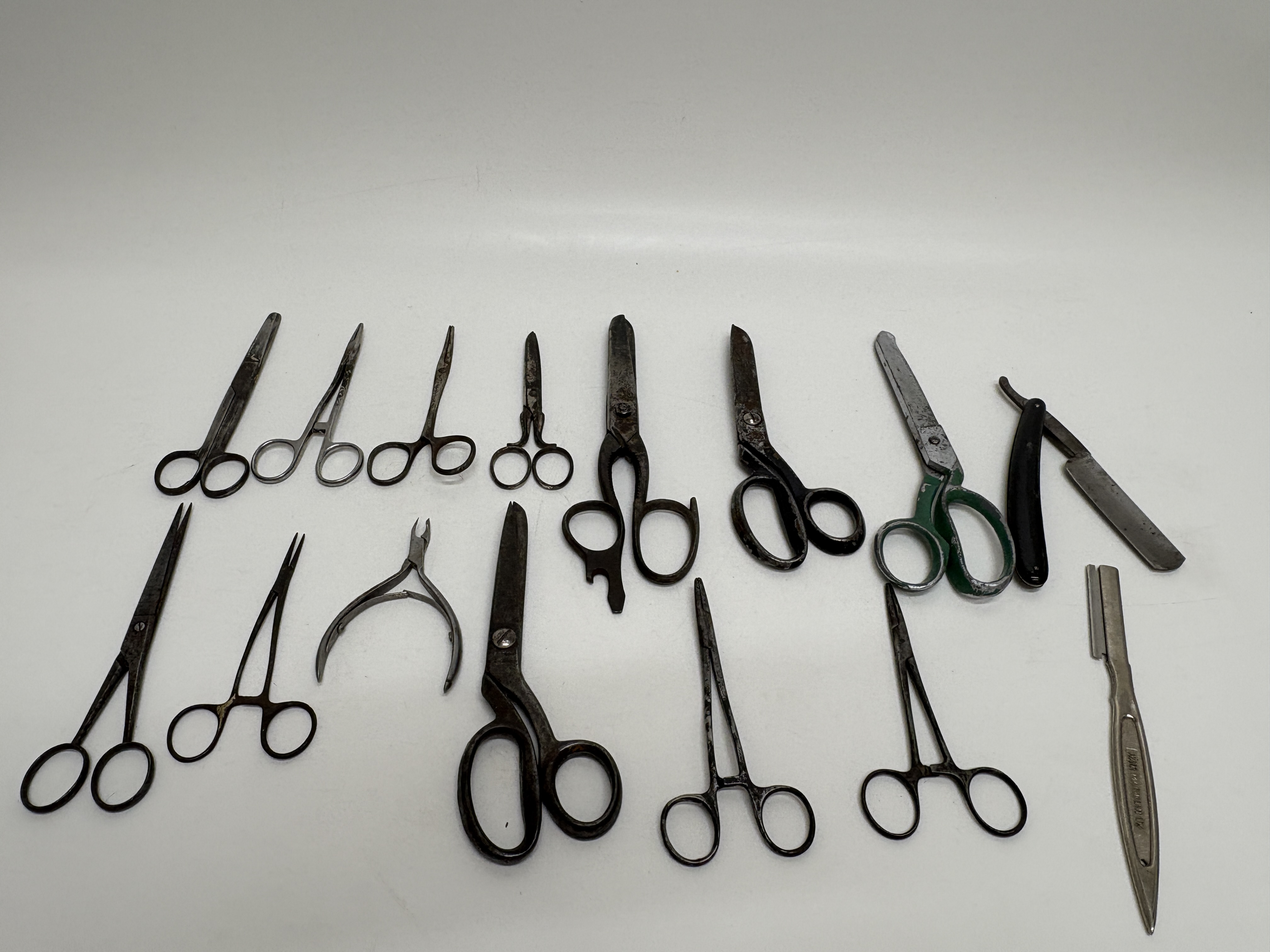 A Collection of Fourteen Vintage and Antique Metal Tools Including Surgical and Barbering Instruments