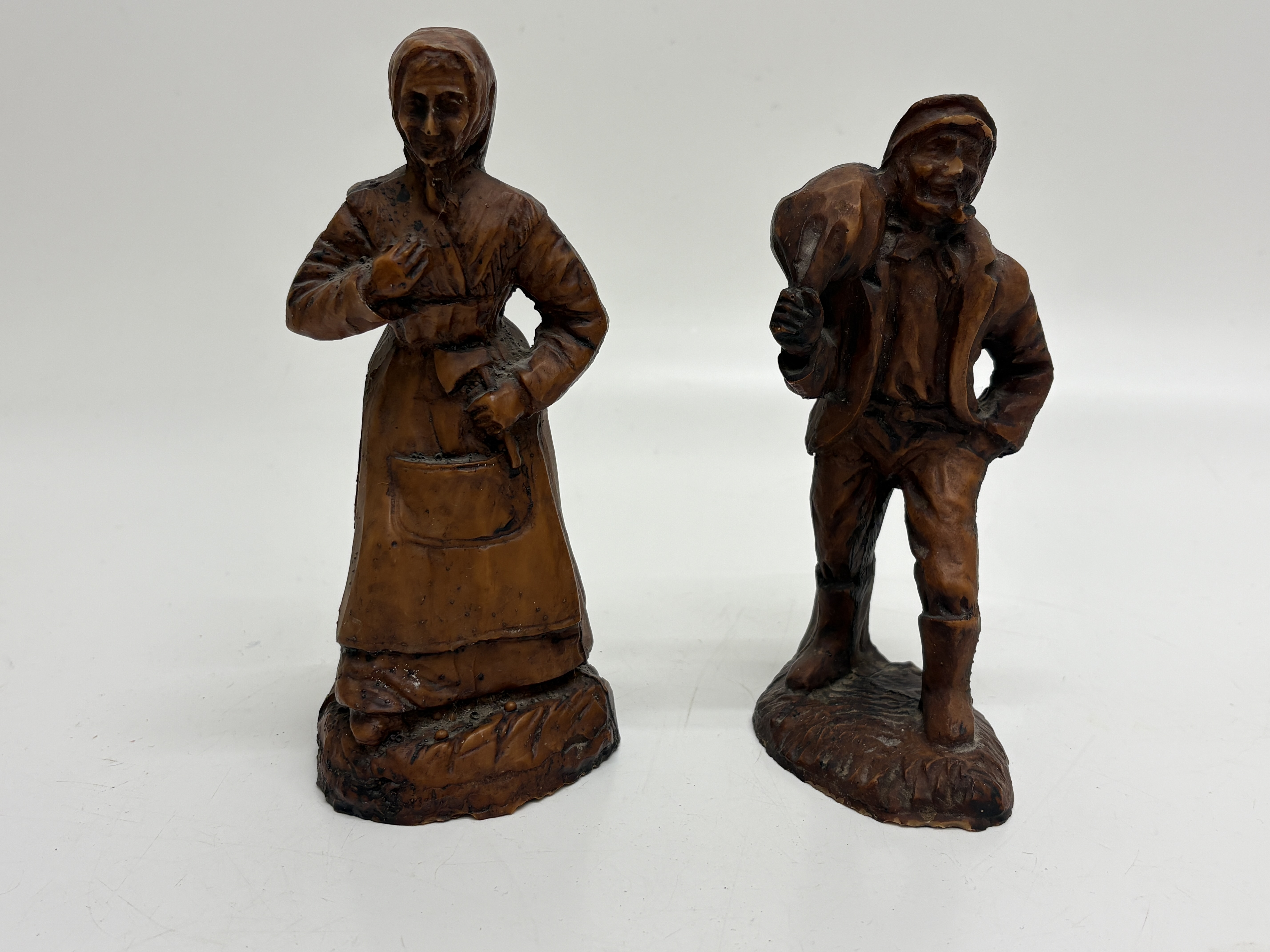 A Pair of Rustic Moulded Composition Peasant Figurines