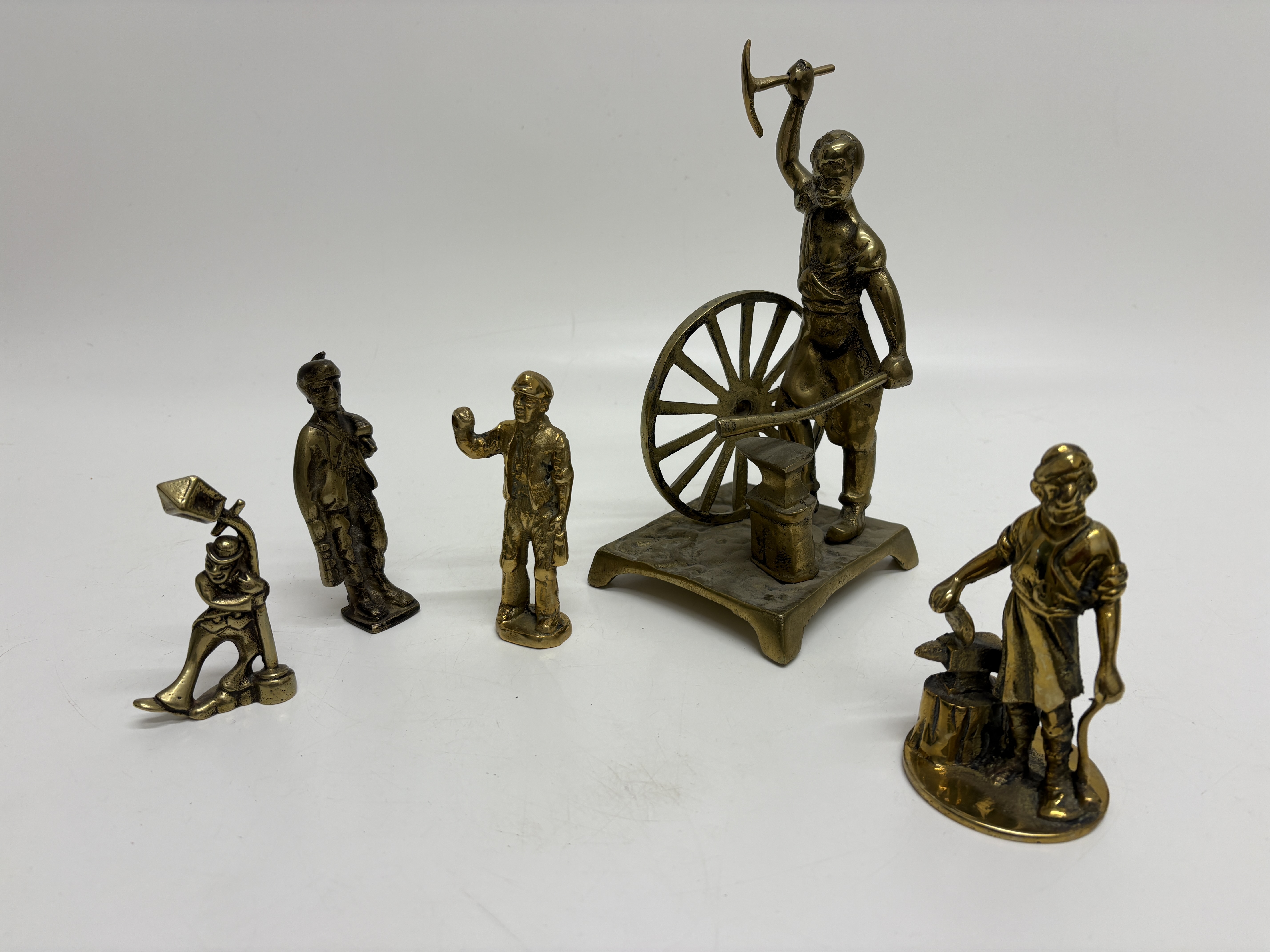 A Collection of Cast Brass Figurines Depicting Various Trades and Characters