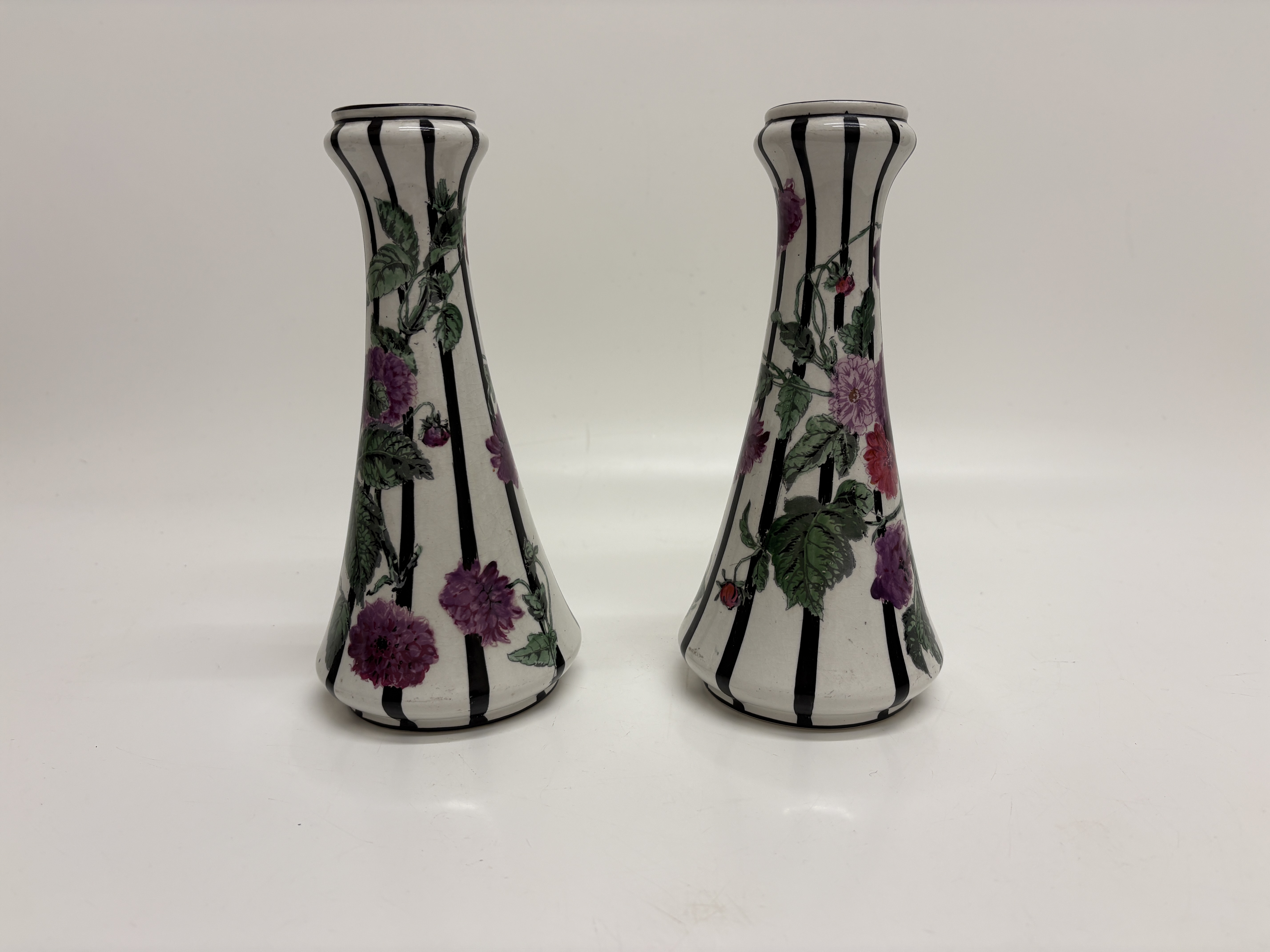 A Pair of George Jones and Sons Crescent Pottery Floral Candlesticks