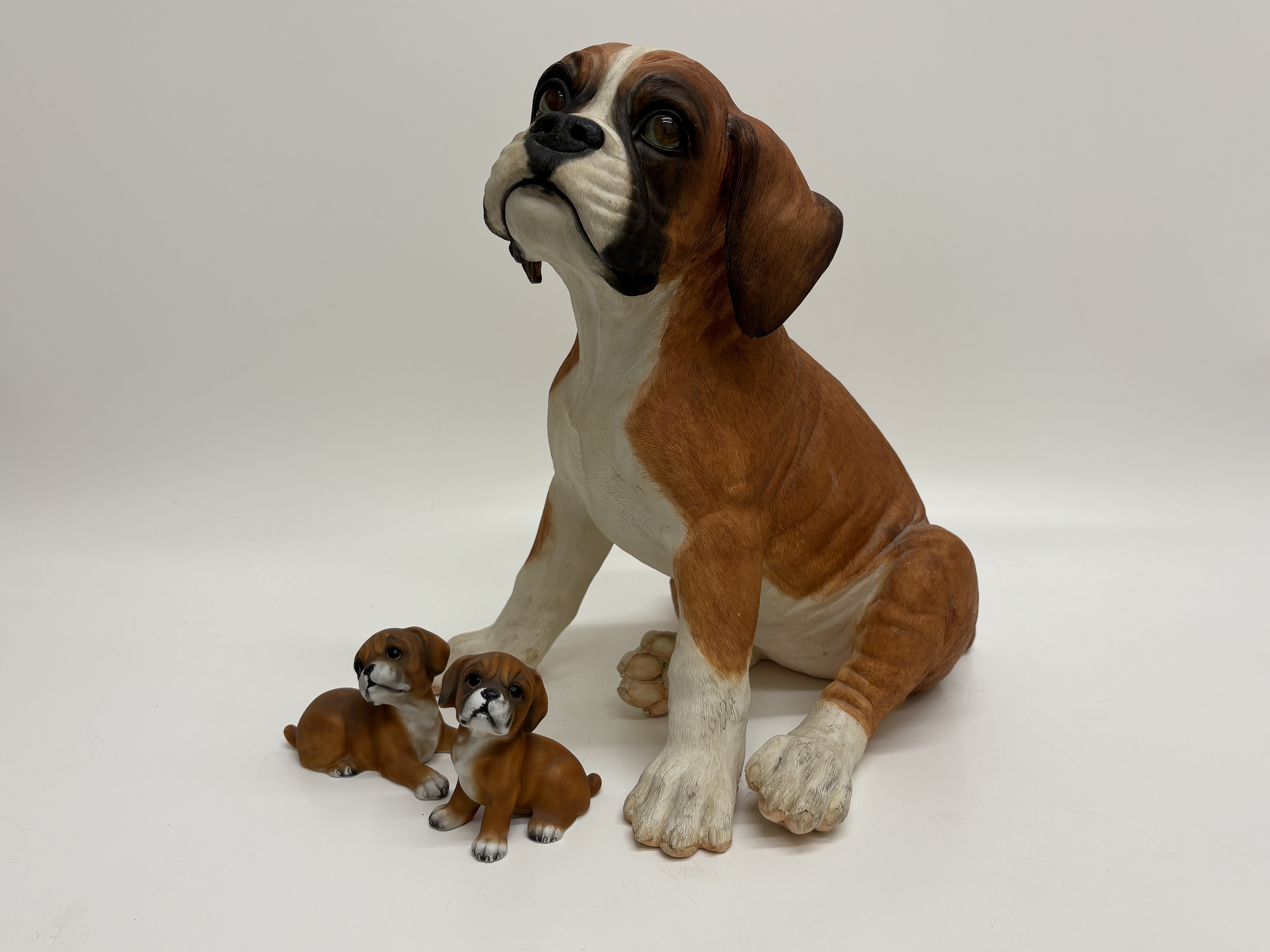 A Trio of Boxer Dog Figurines including Country Artists Puppy Love