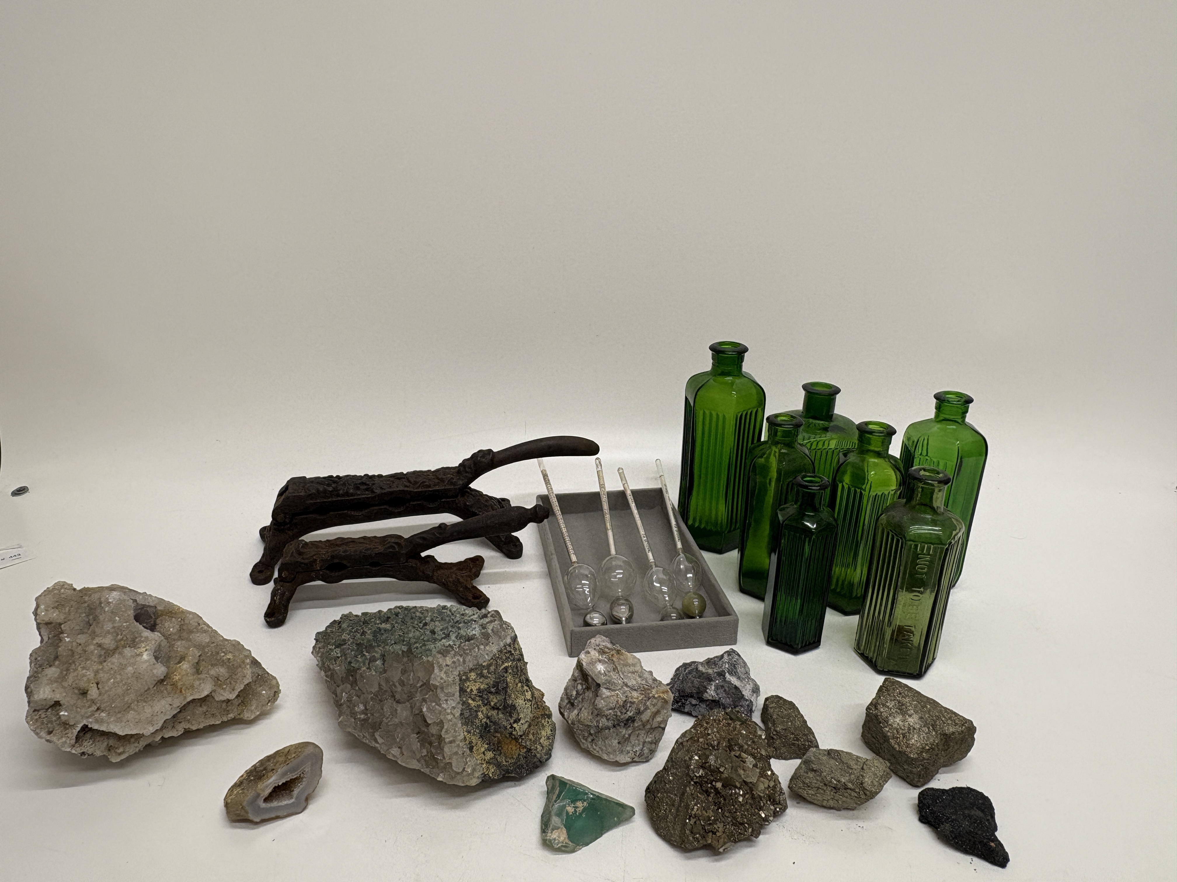 An Assortment of Mineral Specimens, Antique Pharmaceutical Tools, Scientific Instruments, and Green Glass Apothecary Bottles