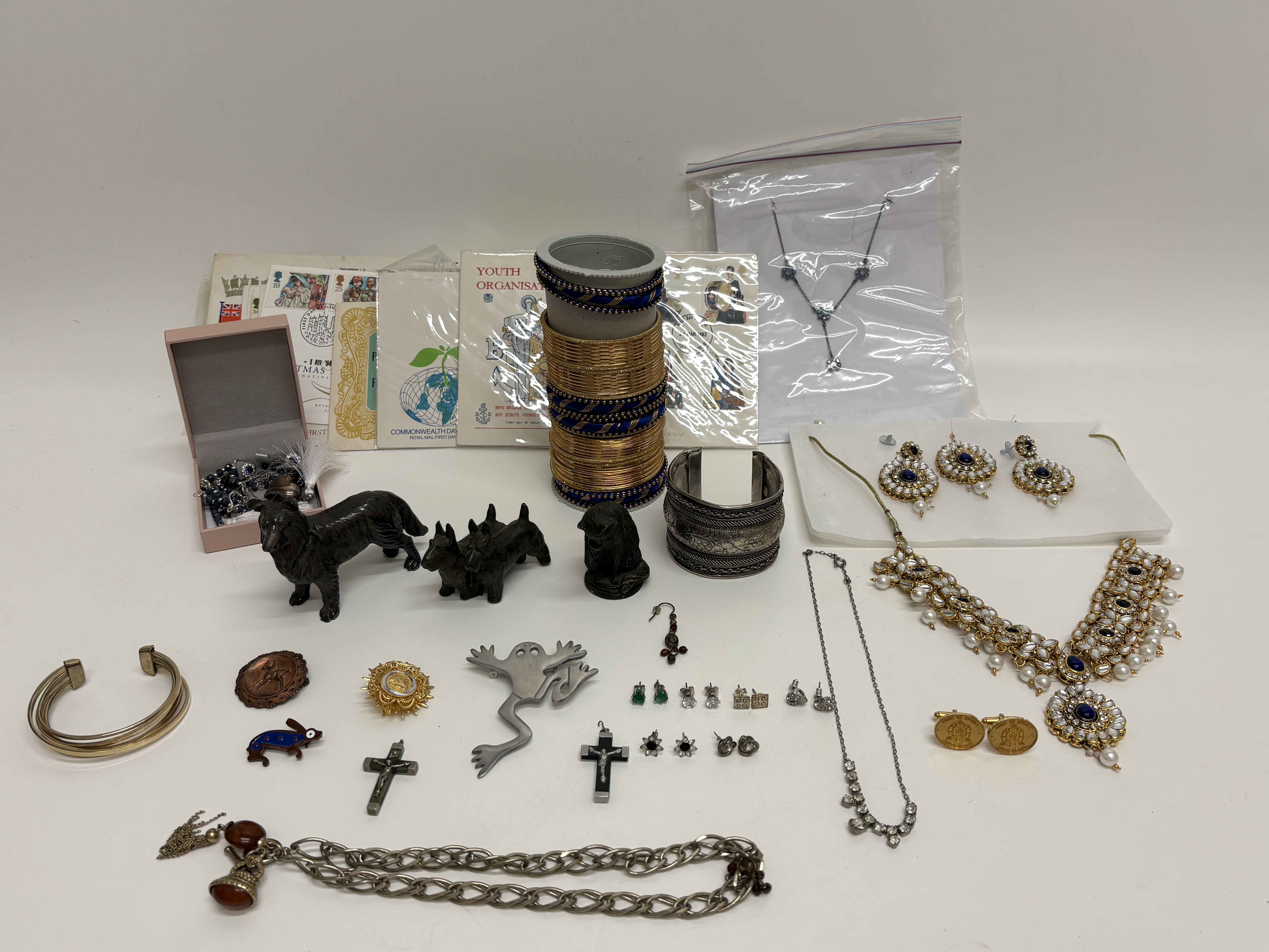 An Assortment of Costume Jewellery, Metal Figurines, and British First Day Covers