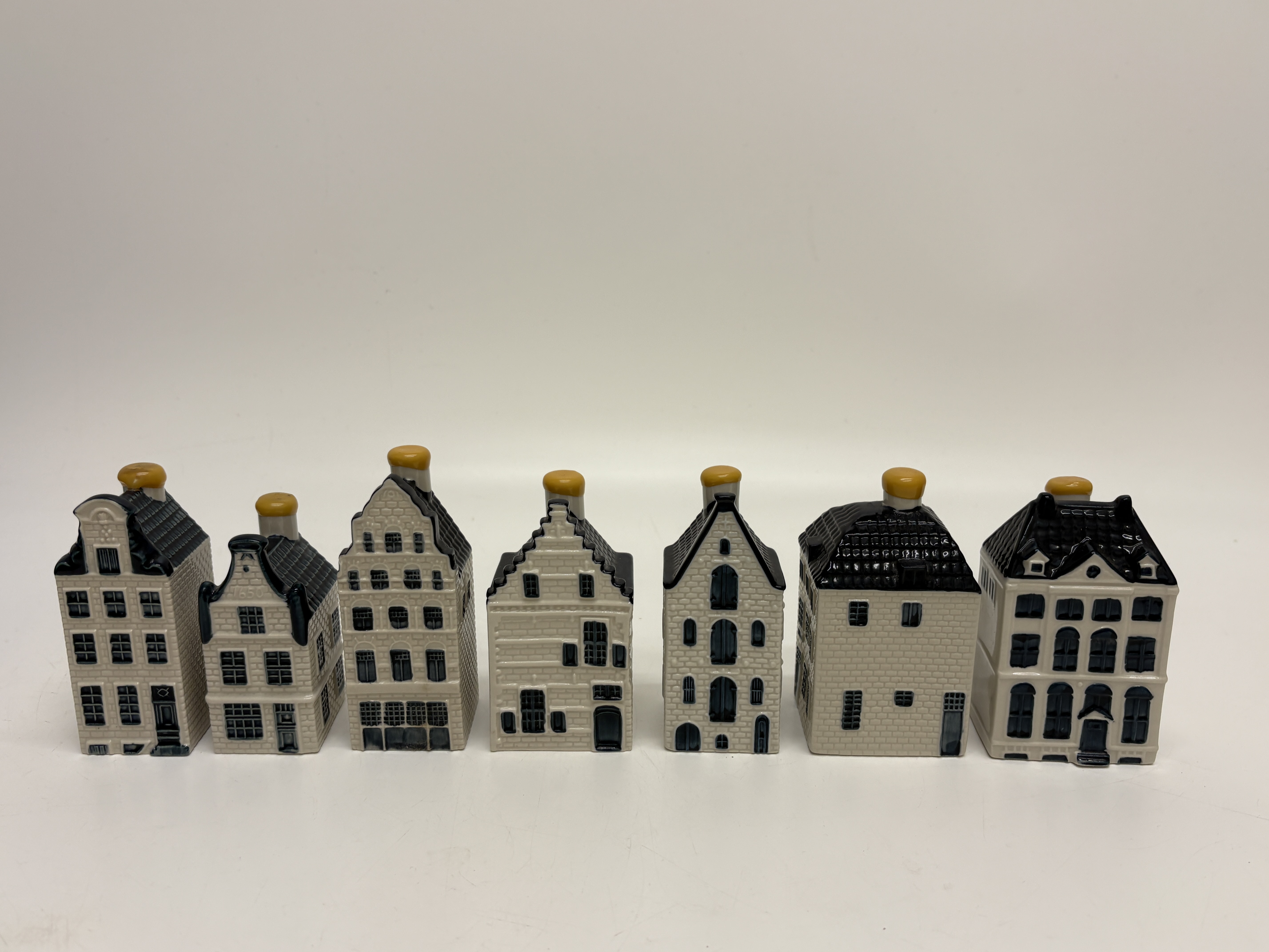 A set of seven KLM Royal Dutch Airlines Bols Delft blue miniature houses