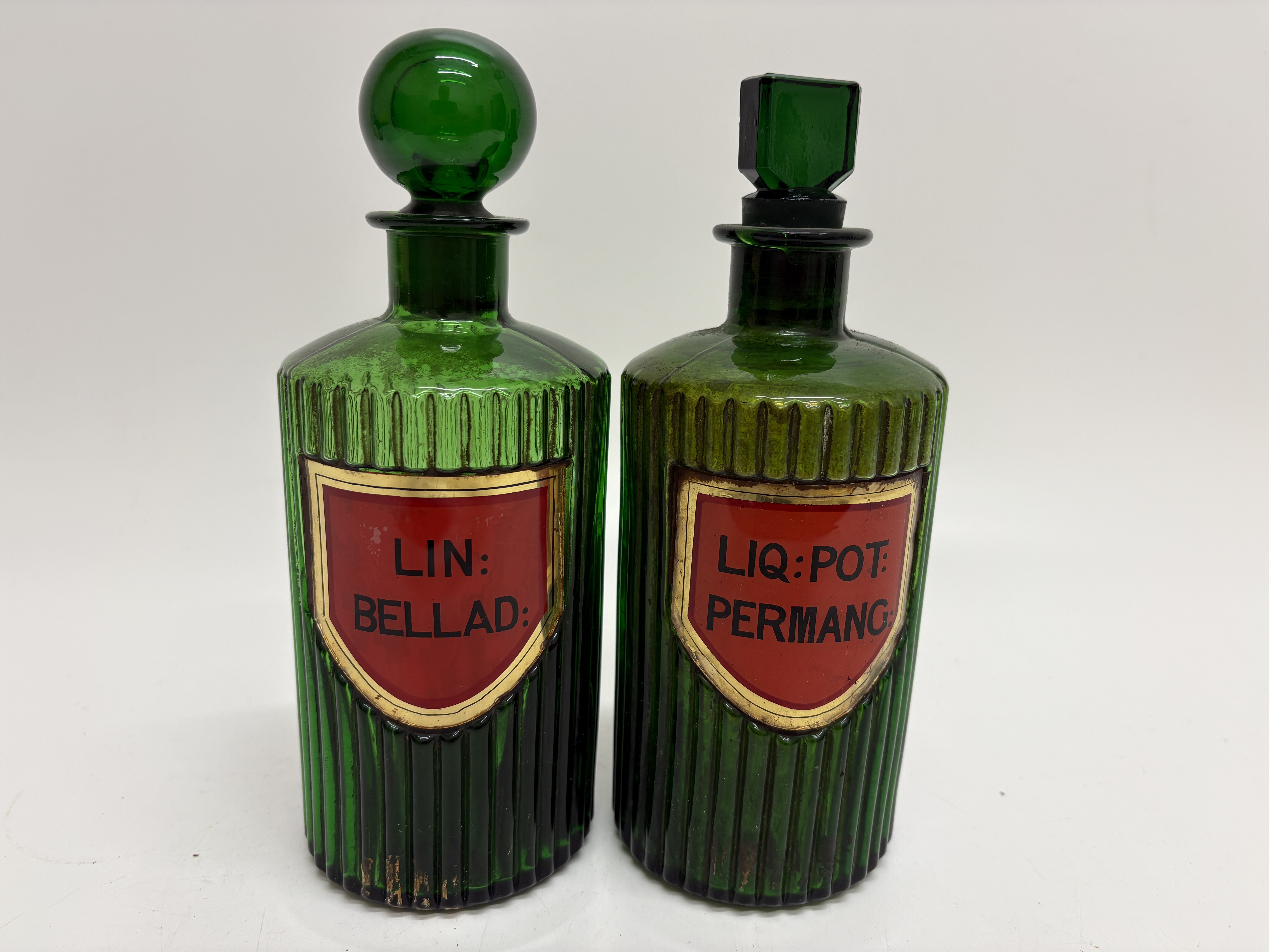 A Pair of Antique Emerald Green Ribbed Glass Apothecary Poison Bottles