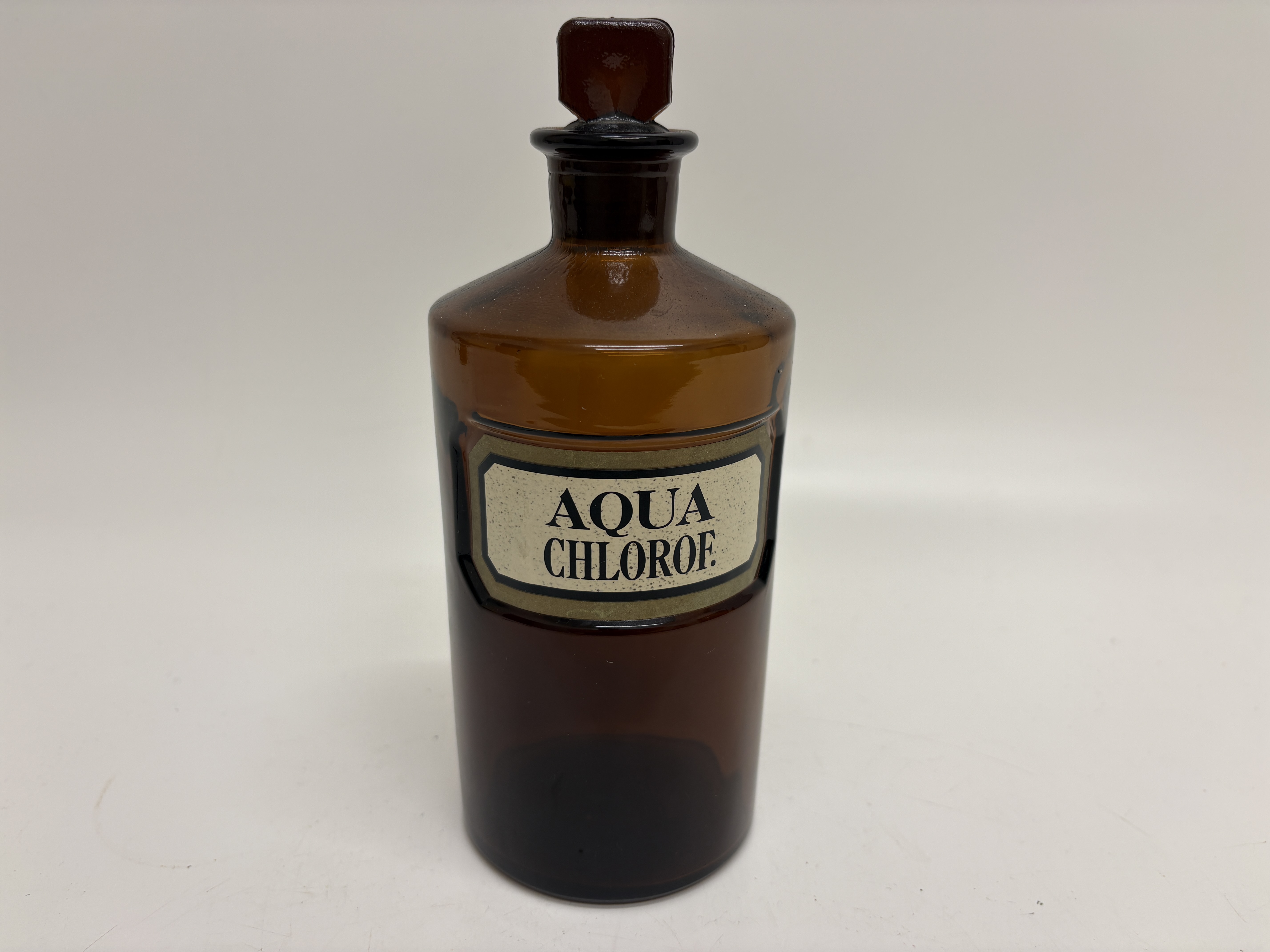 An antique amber glass apothecary shop round bottle for Aqua Chloroformi