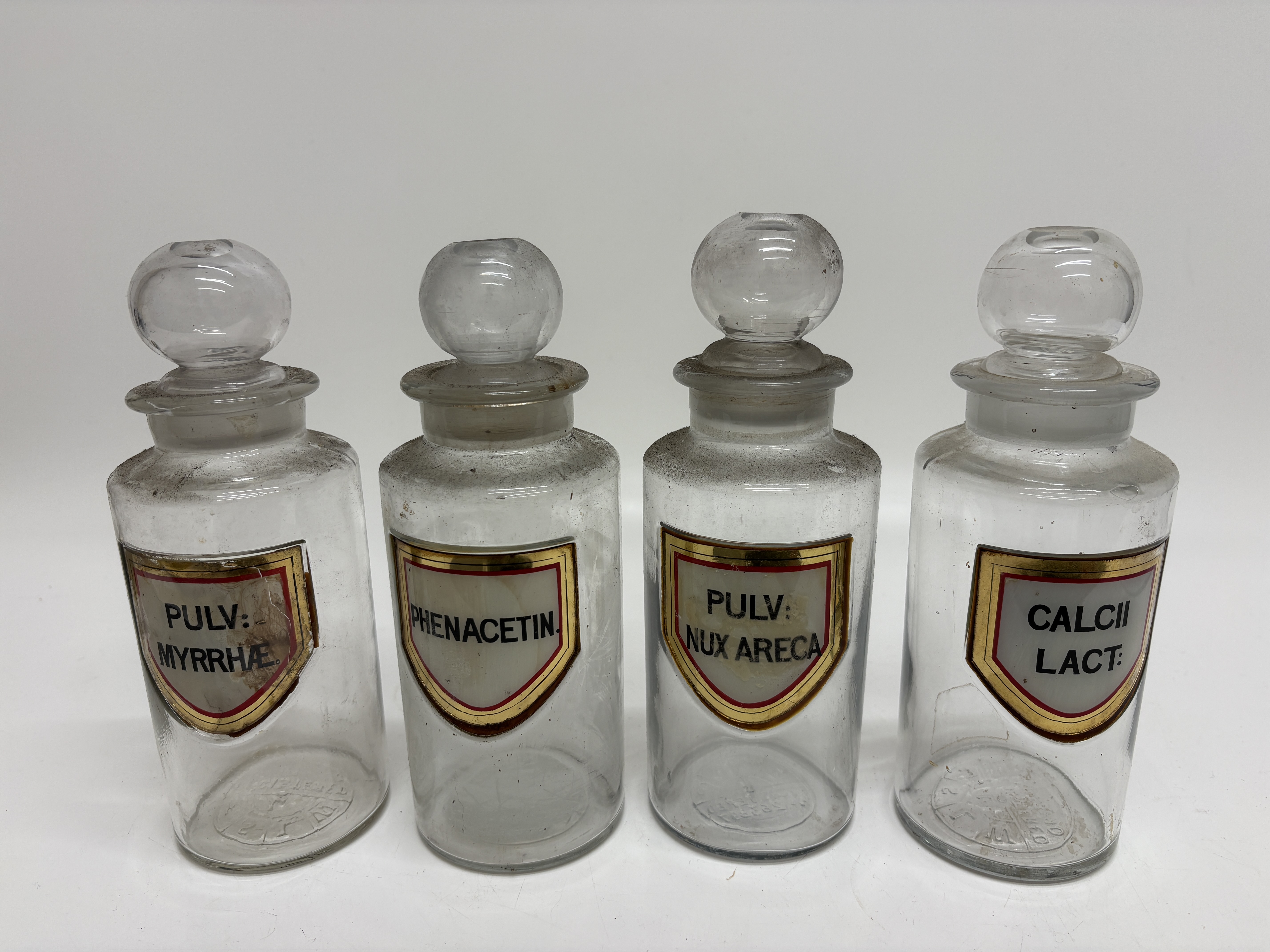 A Set of Four Whitall Tatum and Company Glass Apothecary Jars 22cm