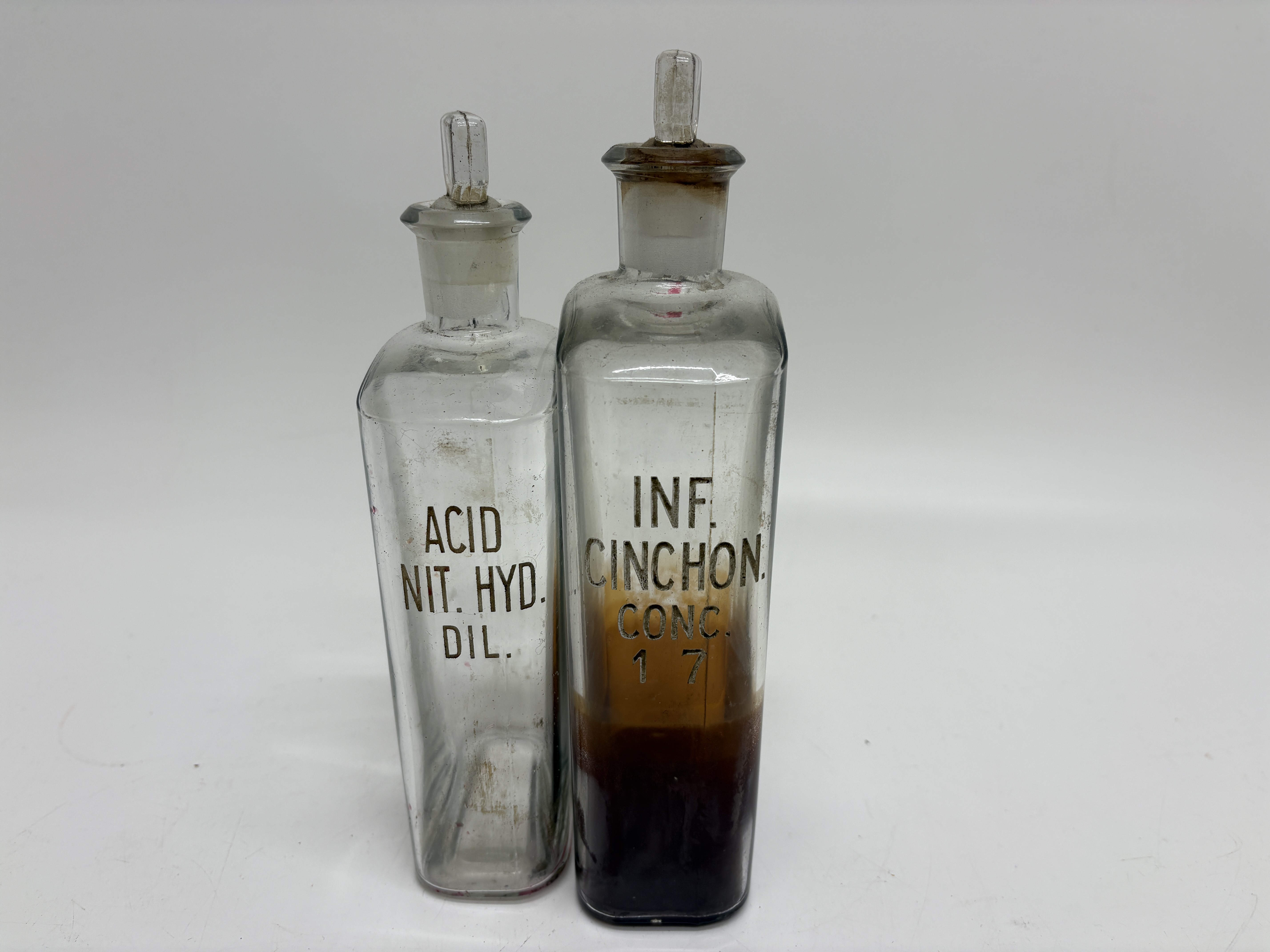A Pair of Antique Clear Glass Apothecary Bottles