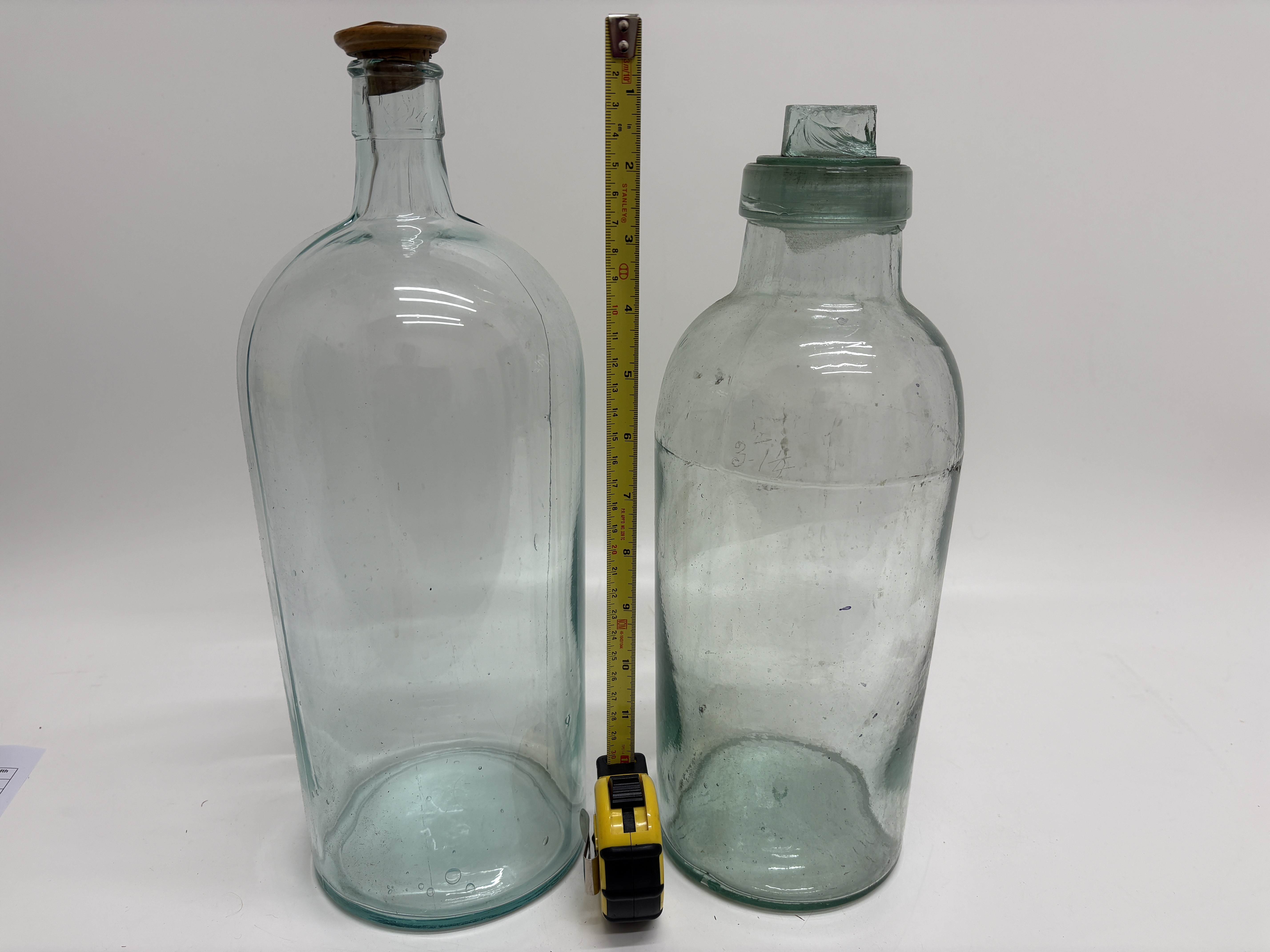 A pair of large aqua glass apothecary storage jars