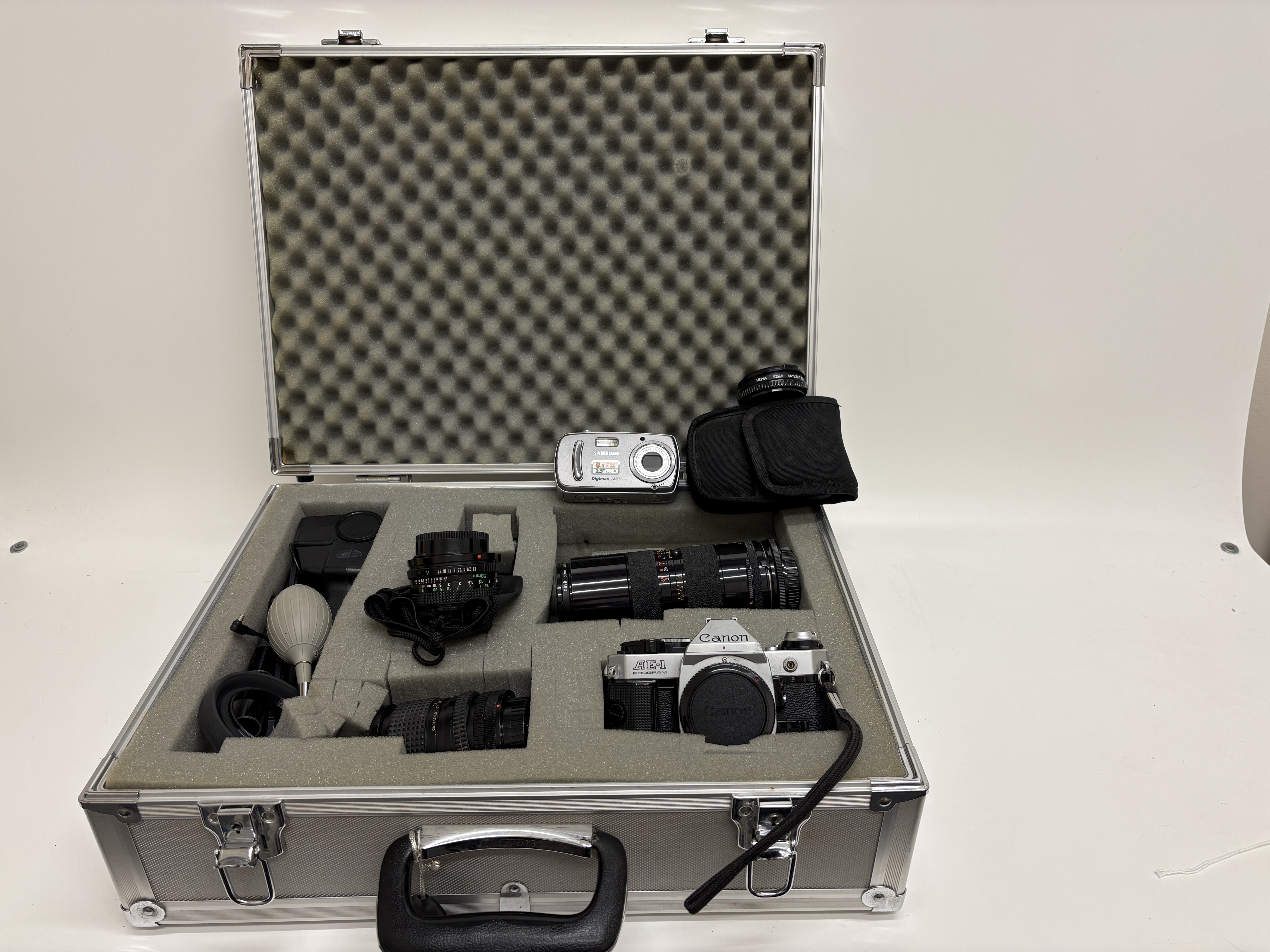 A Collection of Photographic Equipment Including Canon AE-1 Program and Nikon Coolpix P510