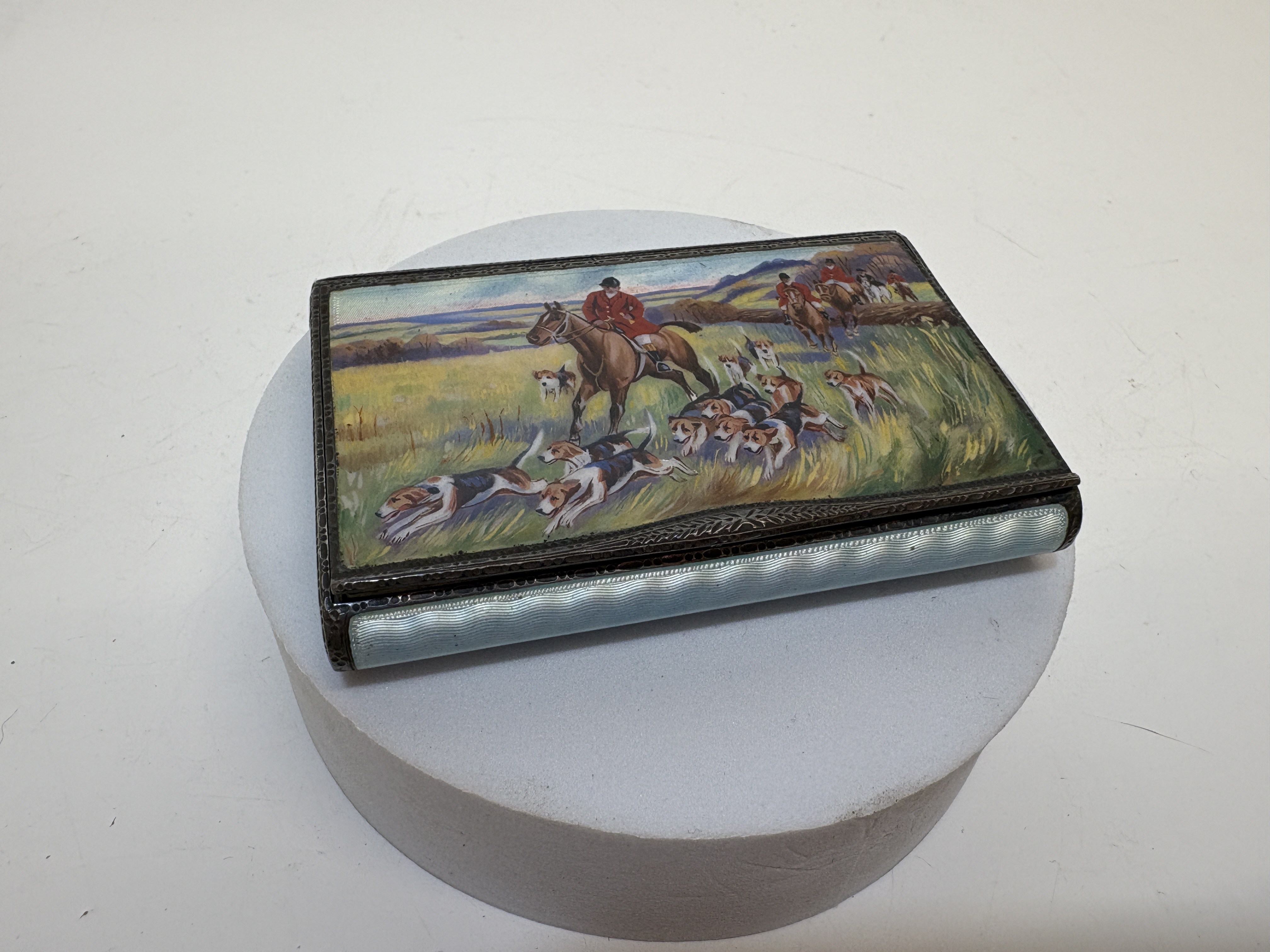 An Art Deco sterling silver and guilloche enamel cigarette case with fox hunting scene Gross circa 125g