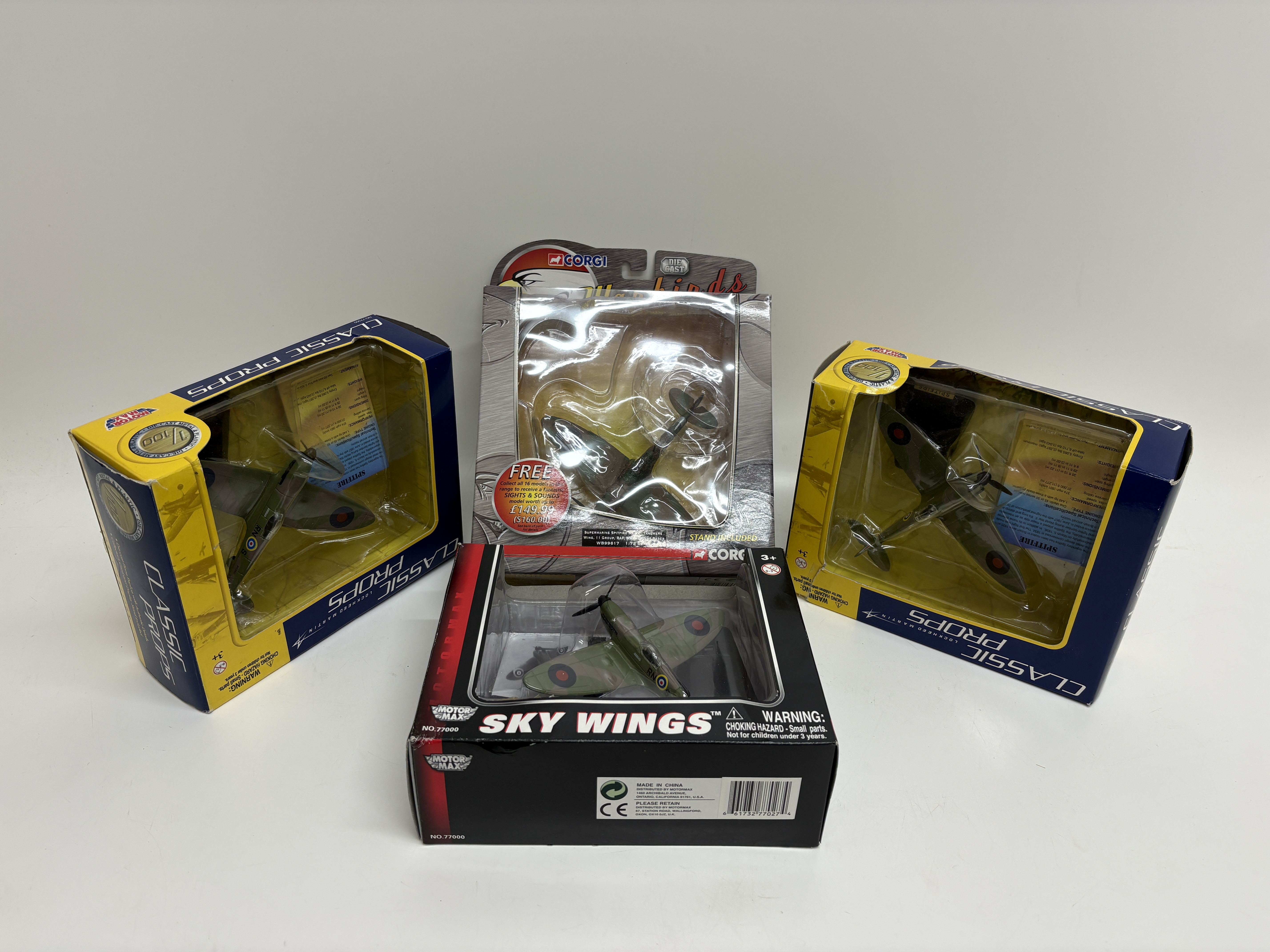 A collection of four boxed die-cast Supermarine Spitfire model aircraft by Corgi and Motor Max