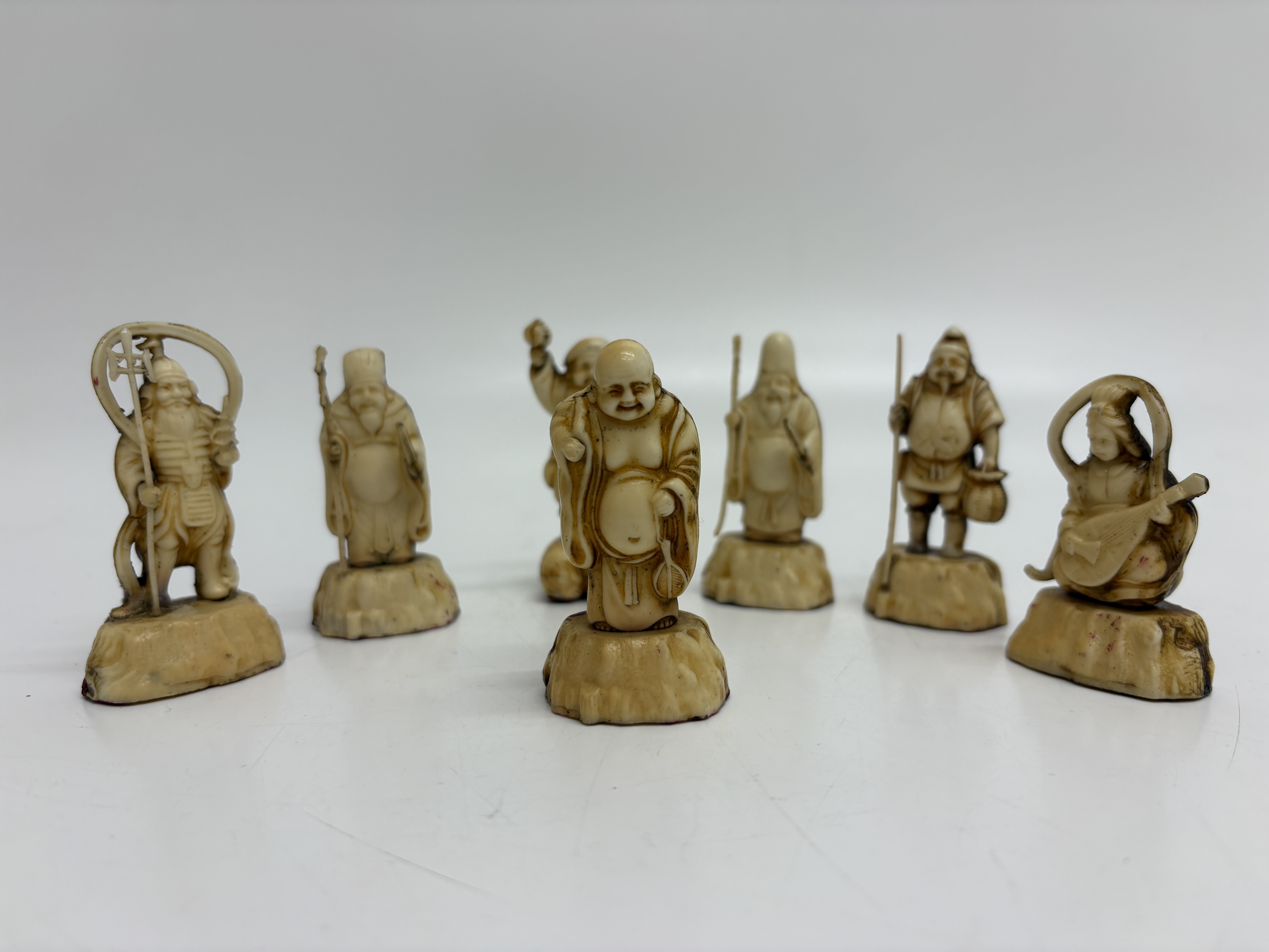 A set of seven 20th century Japanese okimono figurines of the Shichifukujin
