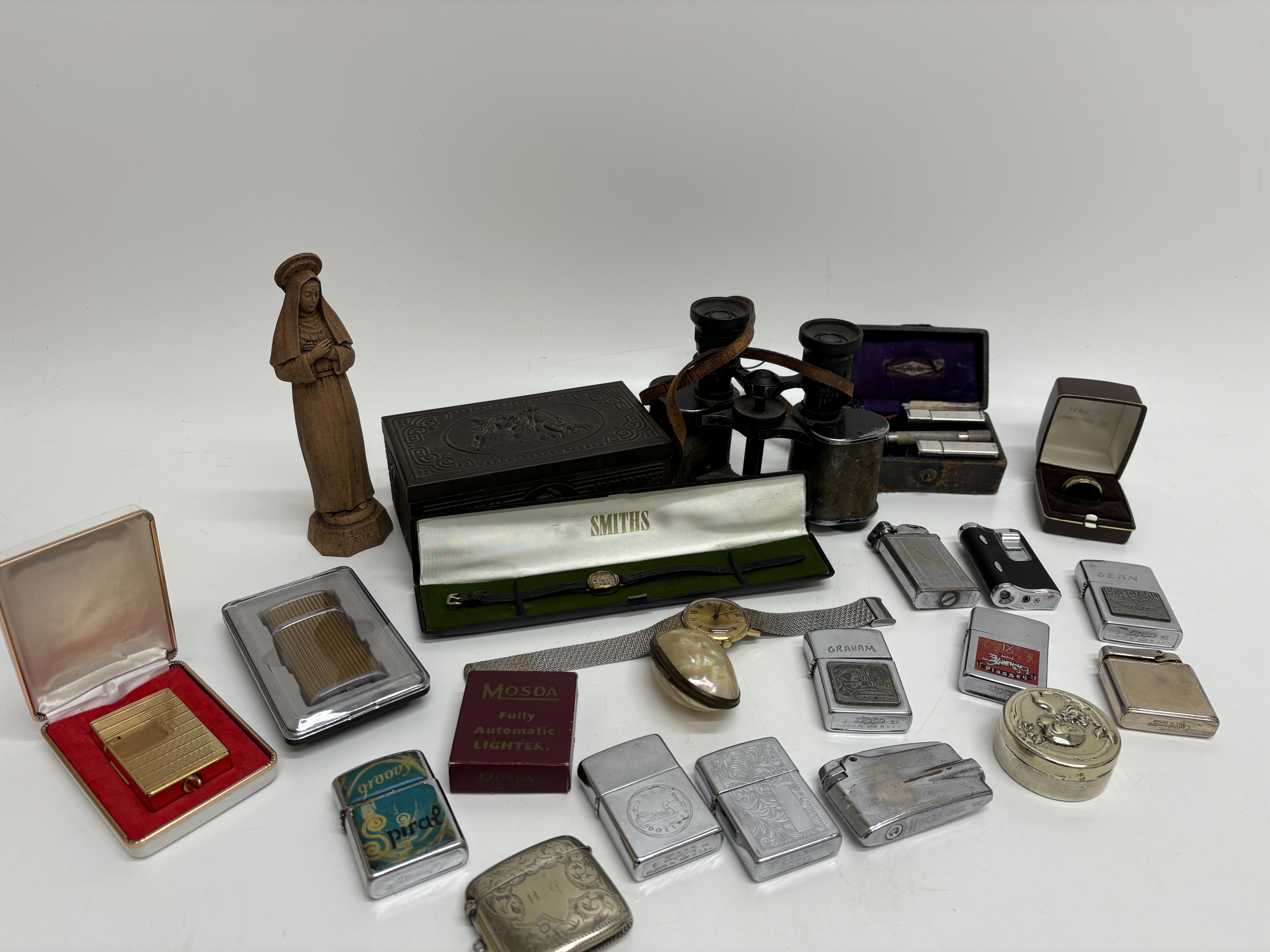 A Collection of Vintage Collectables including Zippo Lighters, Smiths and Sekonda Wristwatches, and Silver Jewellery Charms