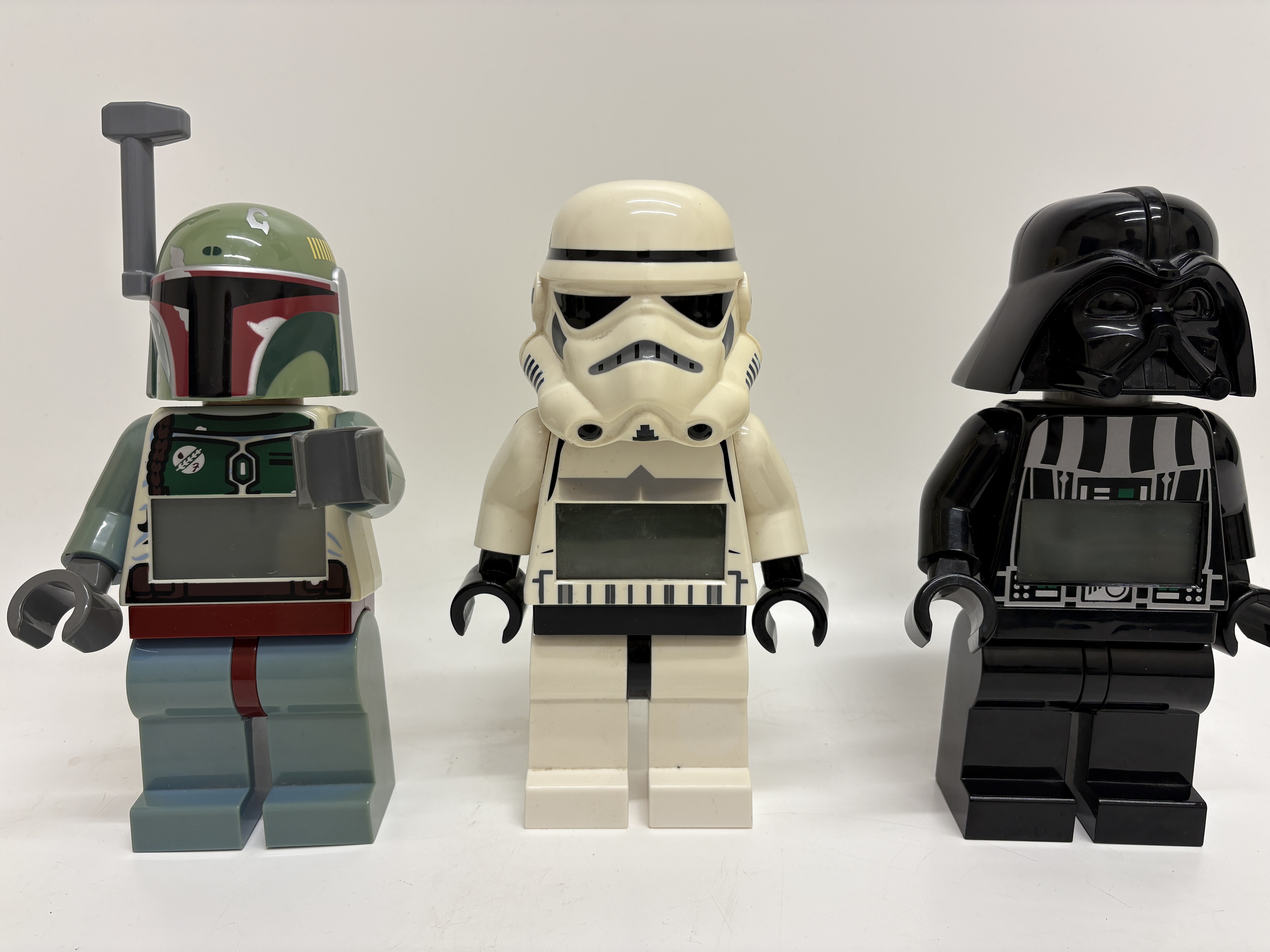 Three LEGO Star Wars digital minifigure alarm clocks including Boba Fett Stormtrooper and Darth Vader