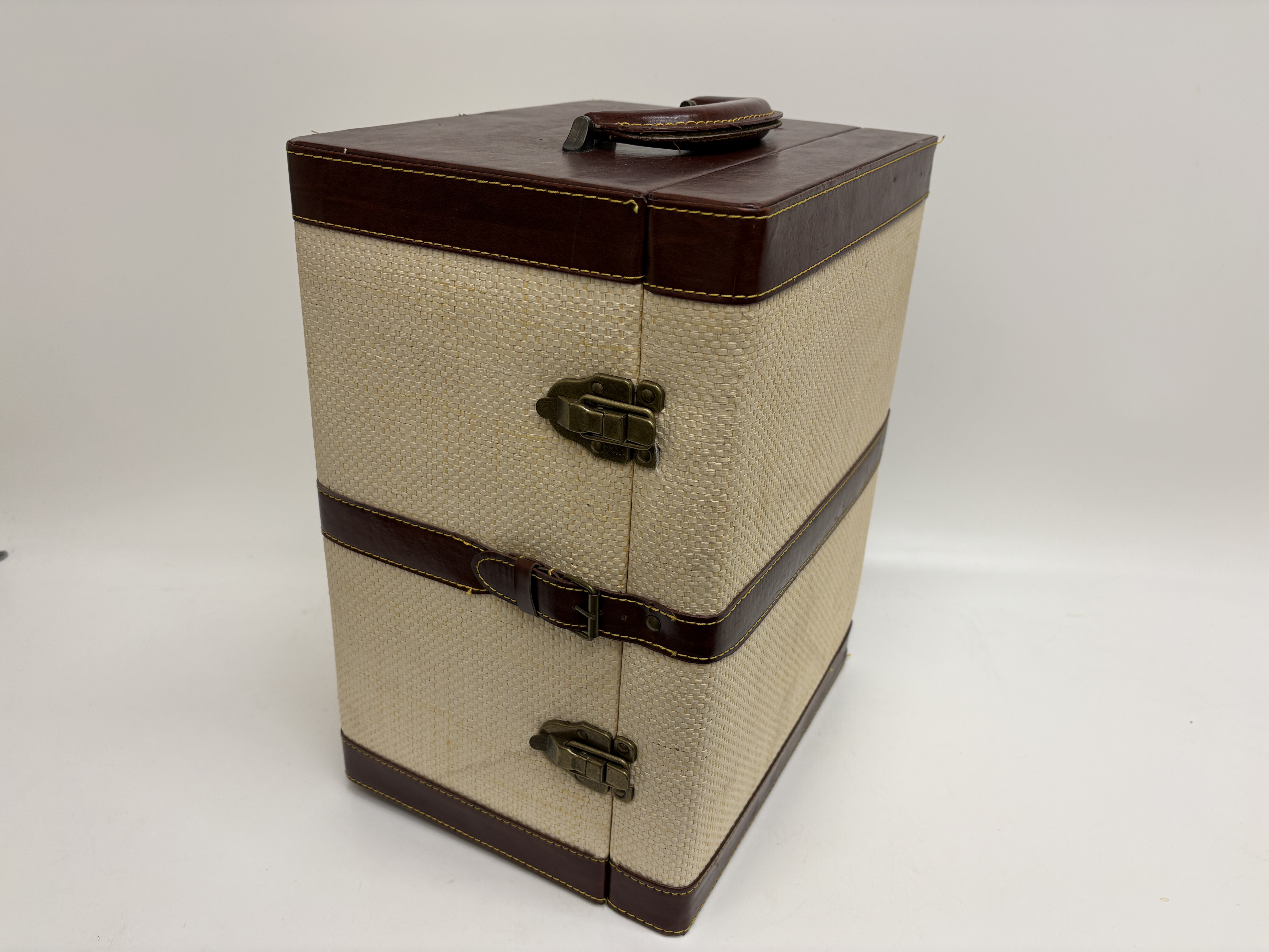A portable travel bar set with clear glassware and vertical carrying case
