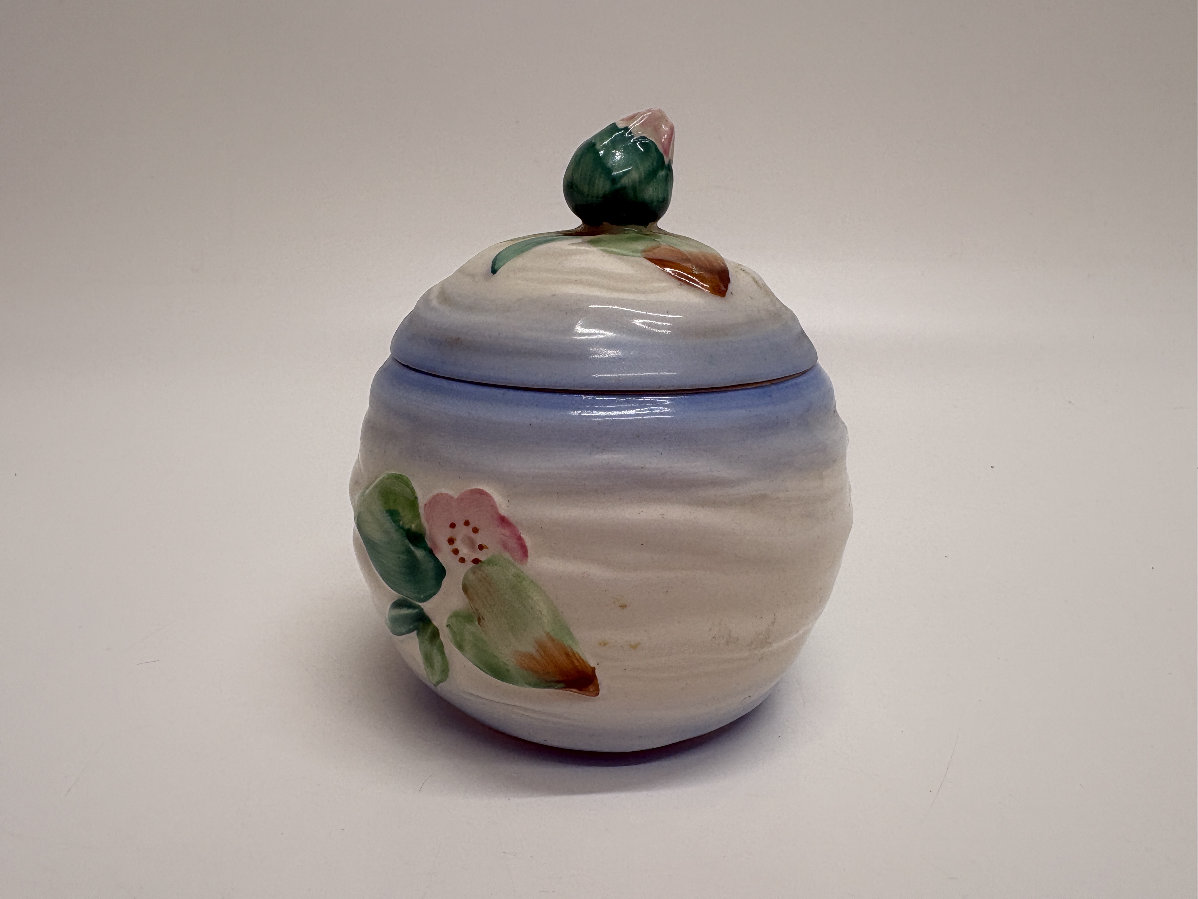 A Clarice Cliff Newport Pottery Water Lily pattern preserve pot and lid