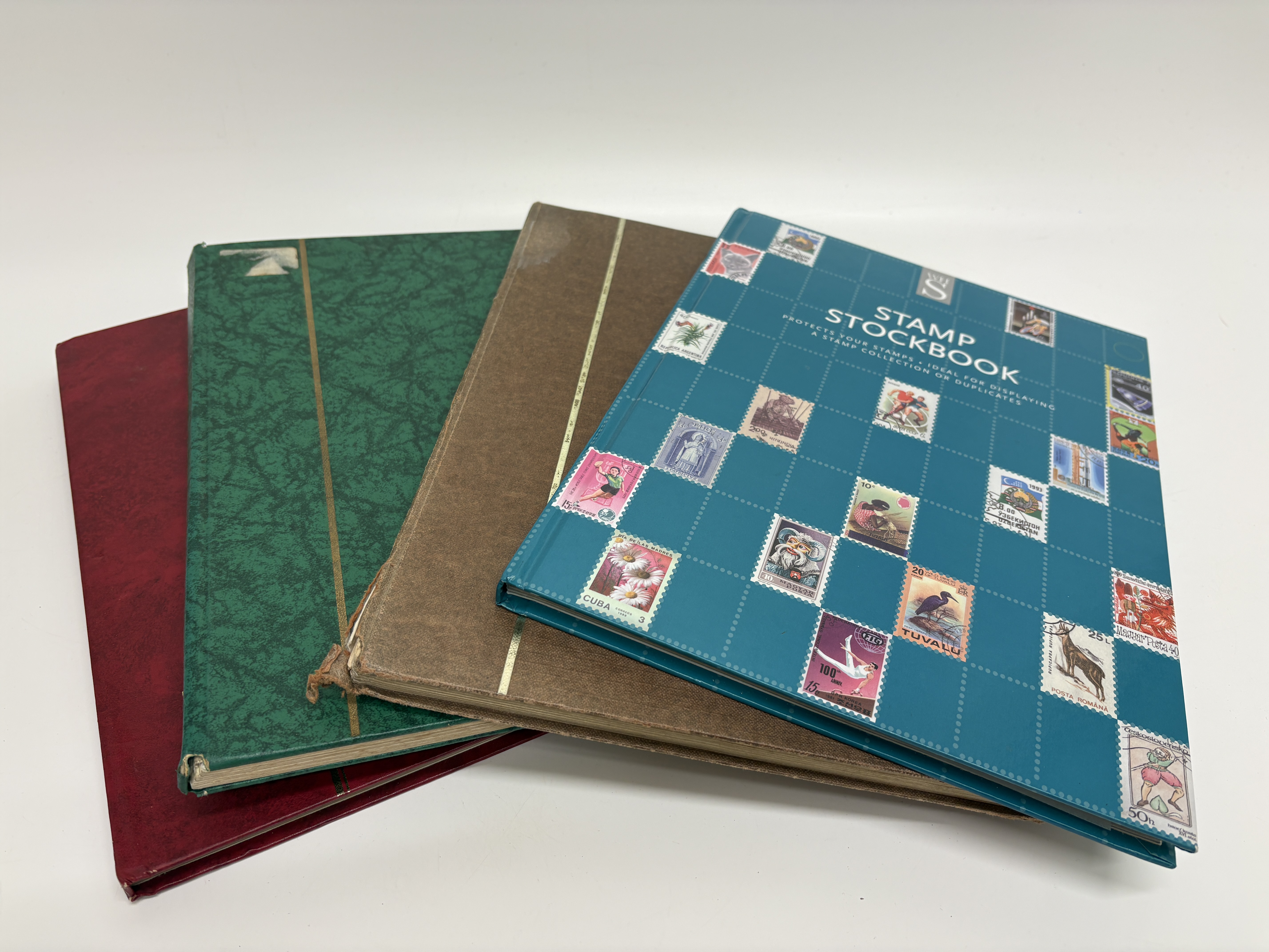 A Collection of Four Worldwide Stamp Stockbooks, Including UK, Eire, and US Issues