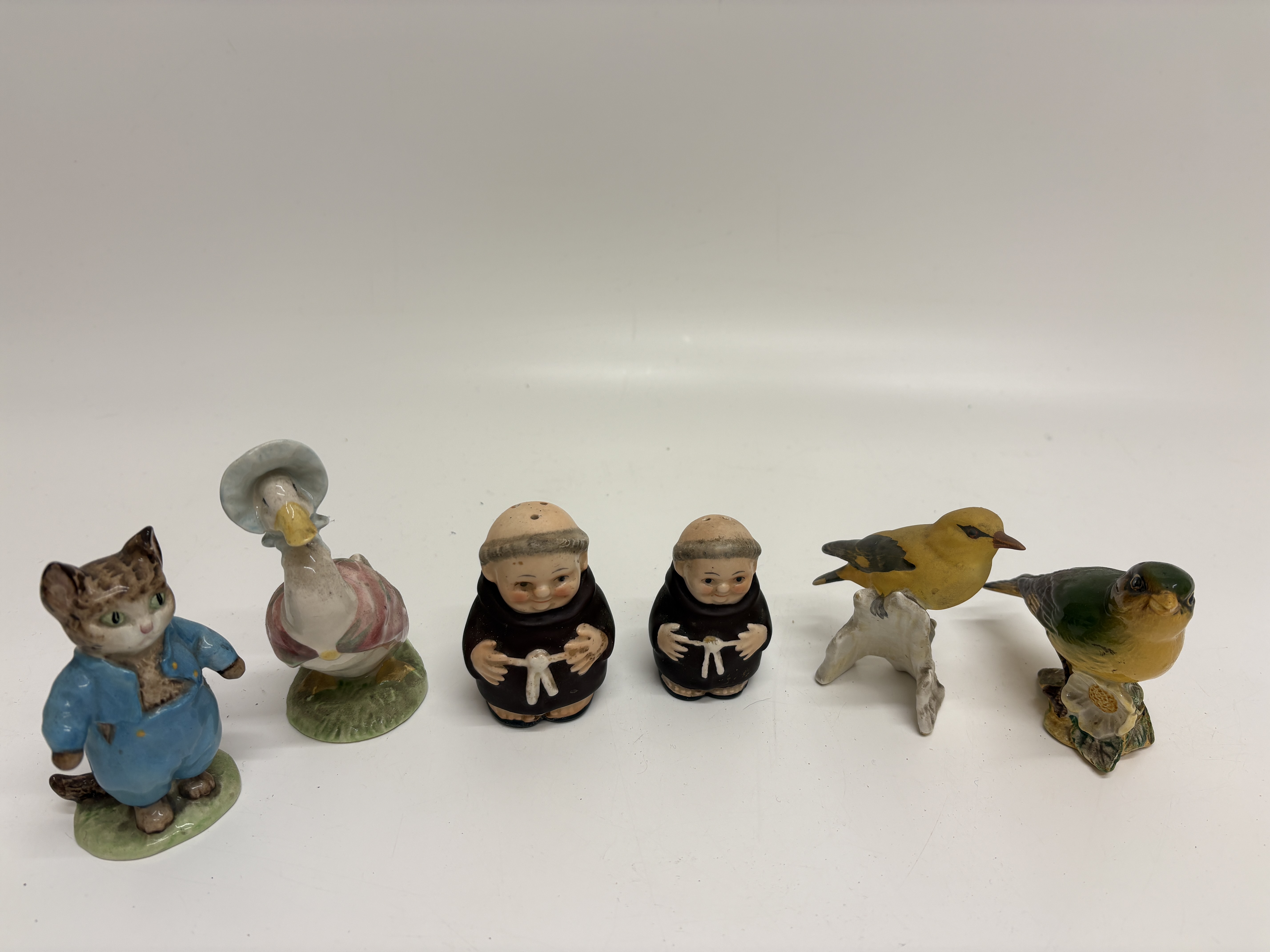 An Assortment of Beswick, Royal Albert, and Goebel Ceramic Figurines