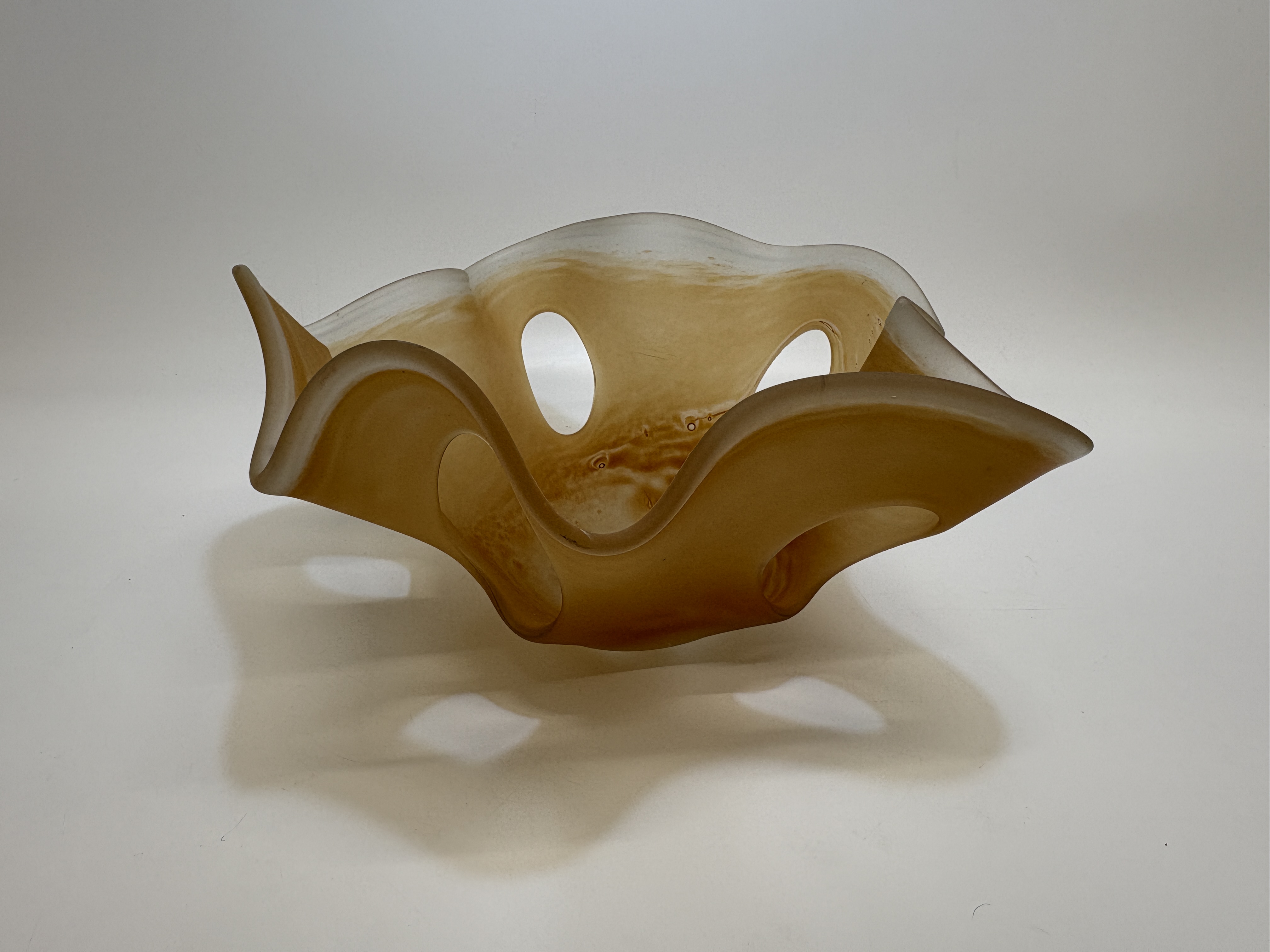 A mid-century modern amber and frosted art glass bowl with teardrop piercings 16x35cm