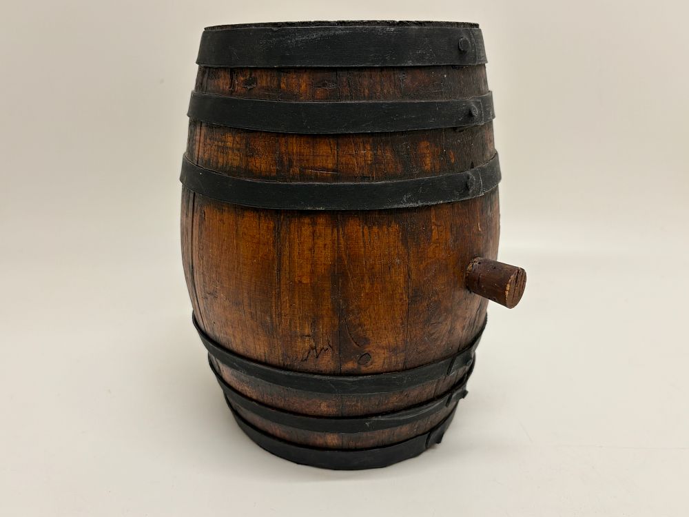 Lot 637: A miniature wooden coopered barrel with metal hoops and side bung