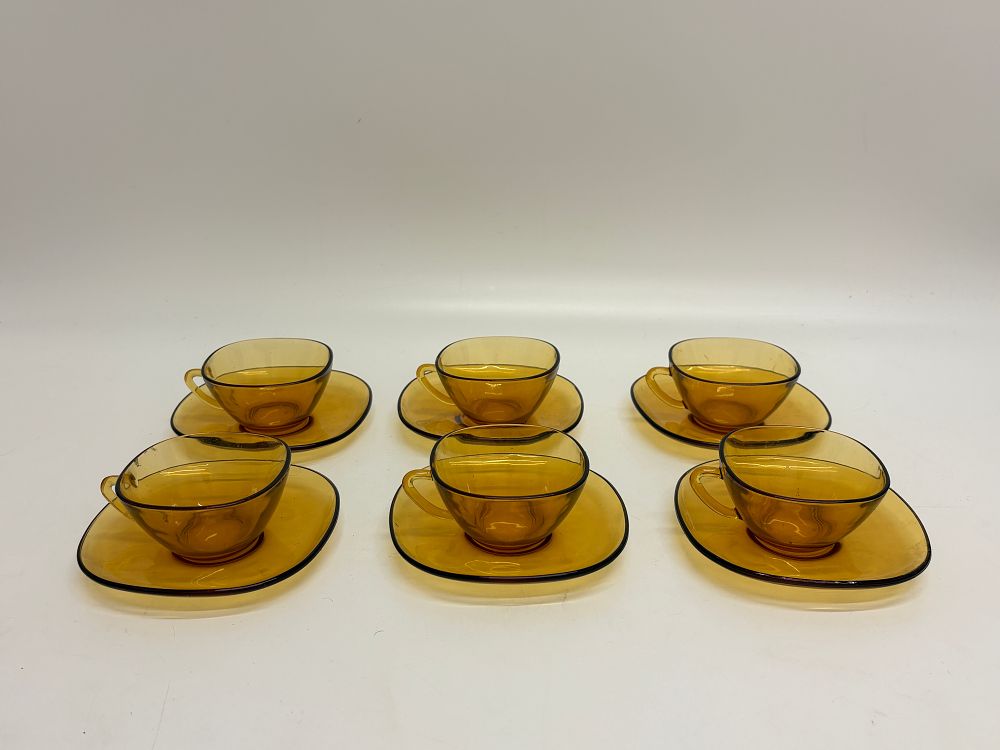 Lot 648: A set of six Vereco France amber glass cups and saucers