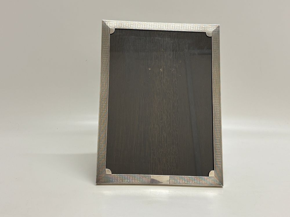 Lot 76: Art Deco sterling silver engine turned photograph frame Birmingham 1927 Silver content circa 150g net