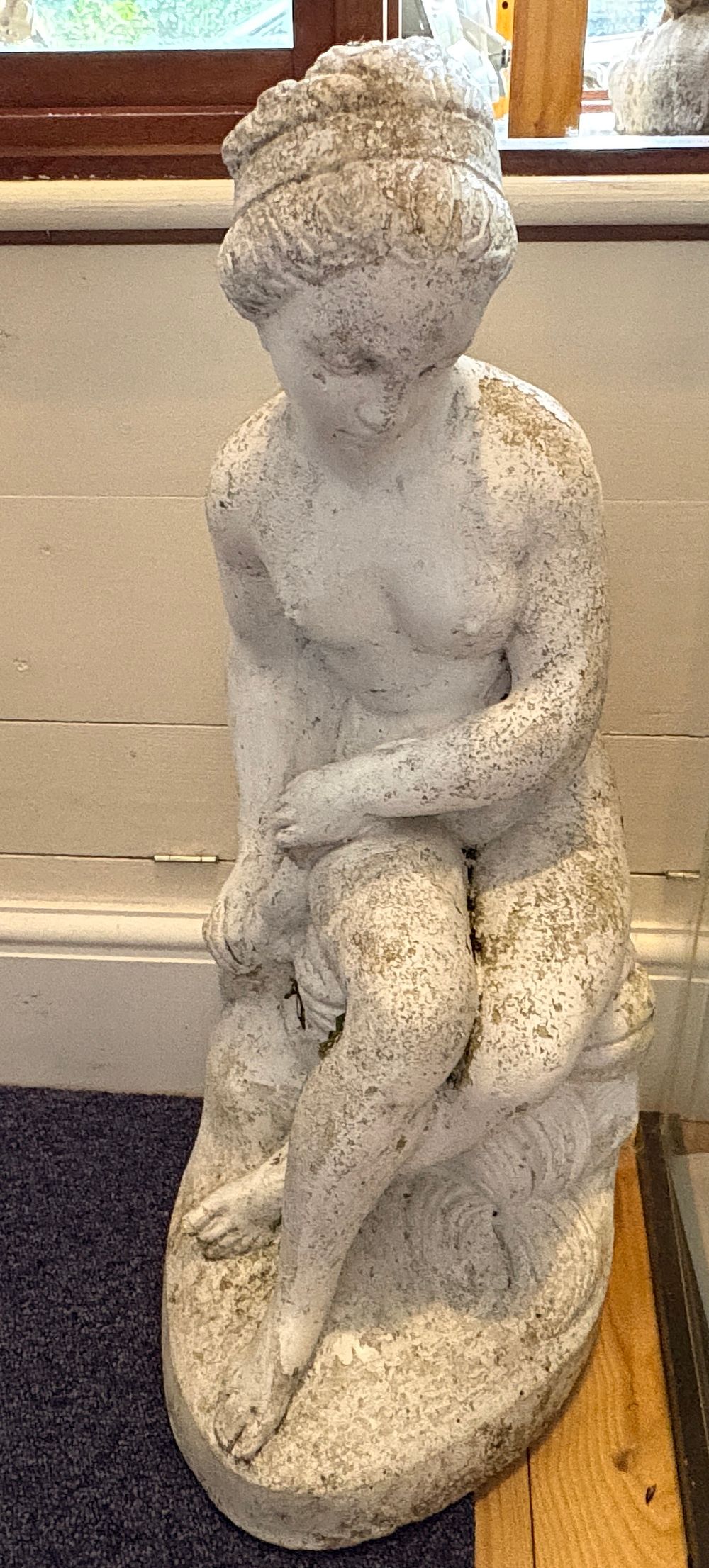 Lot 716: A weathered cast stone garden figure of a seated bathing woman 59cm