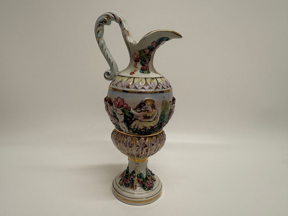 Lot 727: An Italian Polychrome and Gilded Relief-Moulded Earthenware Ewer
